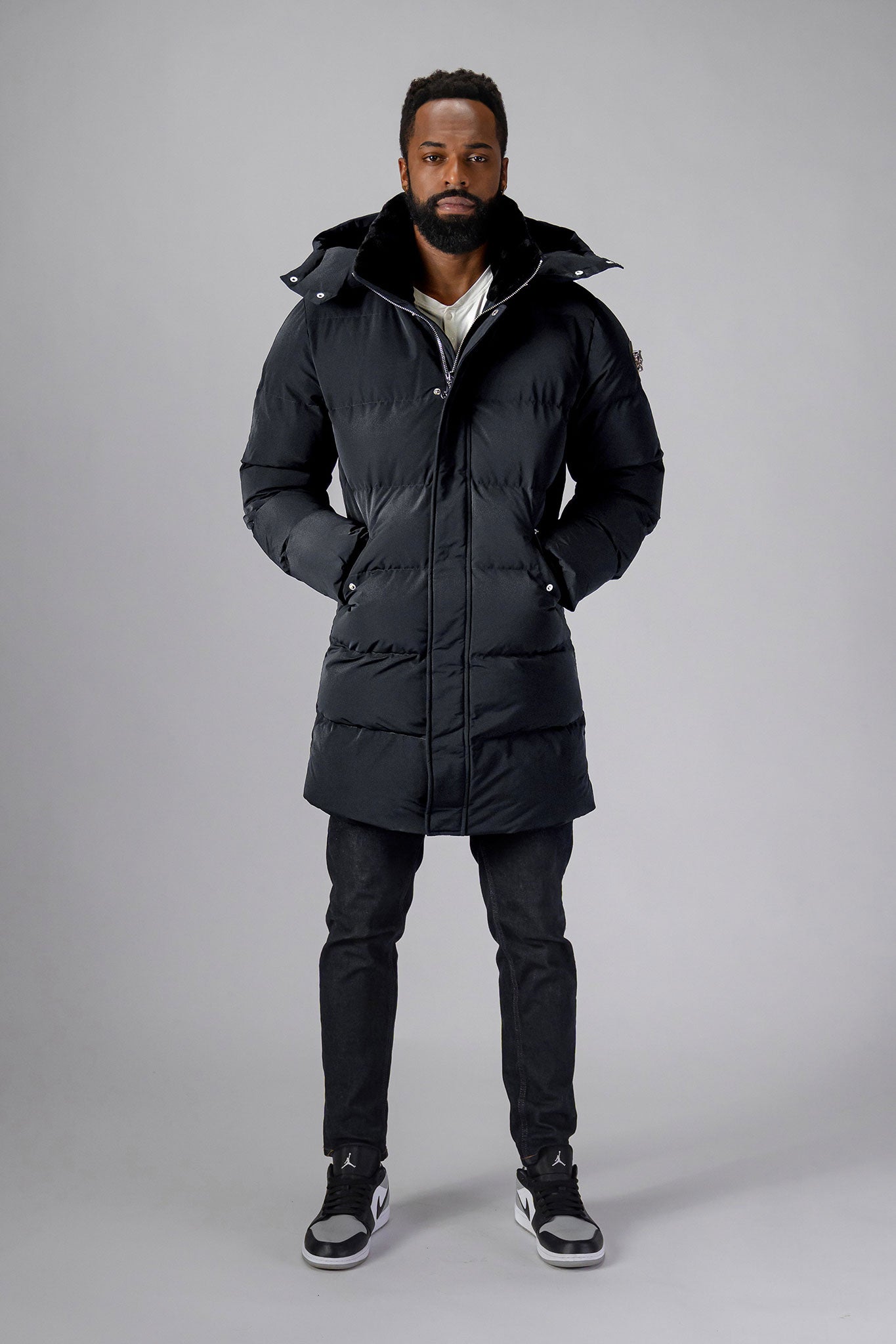 Woodpecker Men's Penguin Long Winter coat. High-end Canadian designer winter coat for men in "Black Diamond" colour. Woodpecker cruelty-free winter coat designed in Canada. Men's heavy weight long length premium designer jacket for winter. Superior quality warm winter coat for men. Moose Knuckles, Canada Goose, Mackage, Montcler, Will Poho, Willbird, Nic Bayley. Extra warm. Shiny parka. Stylish winter jacket. Designer winter coat.