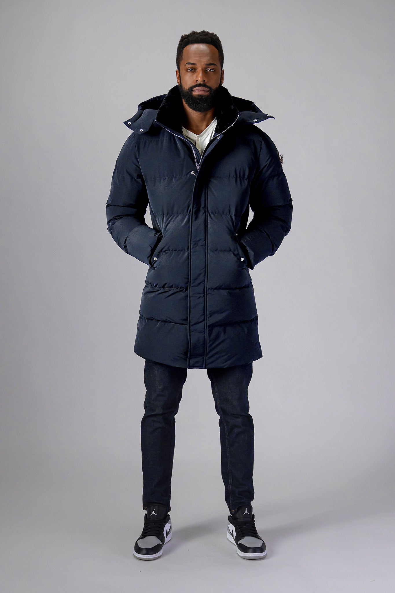 Woodpecker Men's Penguin Long Winter coat. High-end Canadian designer winter coat for men in "Blue Diamond" colour. Woodpecker cruelty-free winter coat designed in Canada. Men's heavy weight long length premium designer jacket for winter. Superior quality warm winter coat for men. Moose Knuckles, Canada Goose, Mackage, Montcler, Will Poho, Willbird, Nic Bayley. Extra warm. Shiny parka. Stylish winter jacket. Designer winter coat.