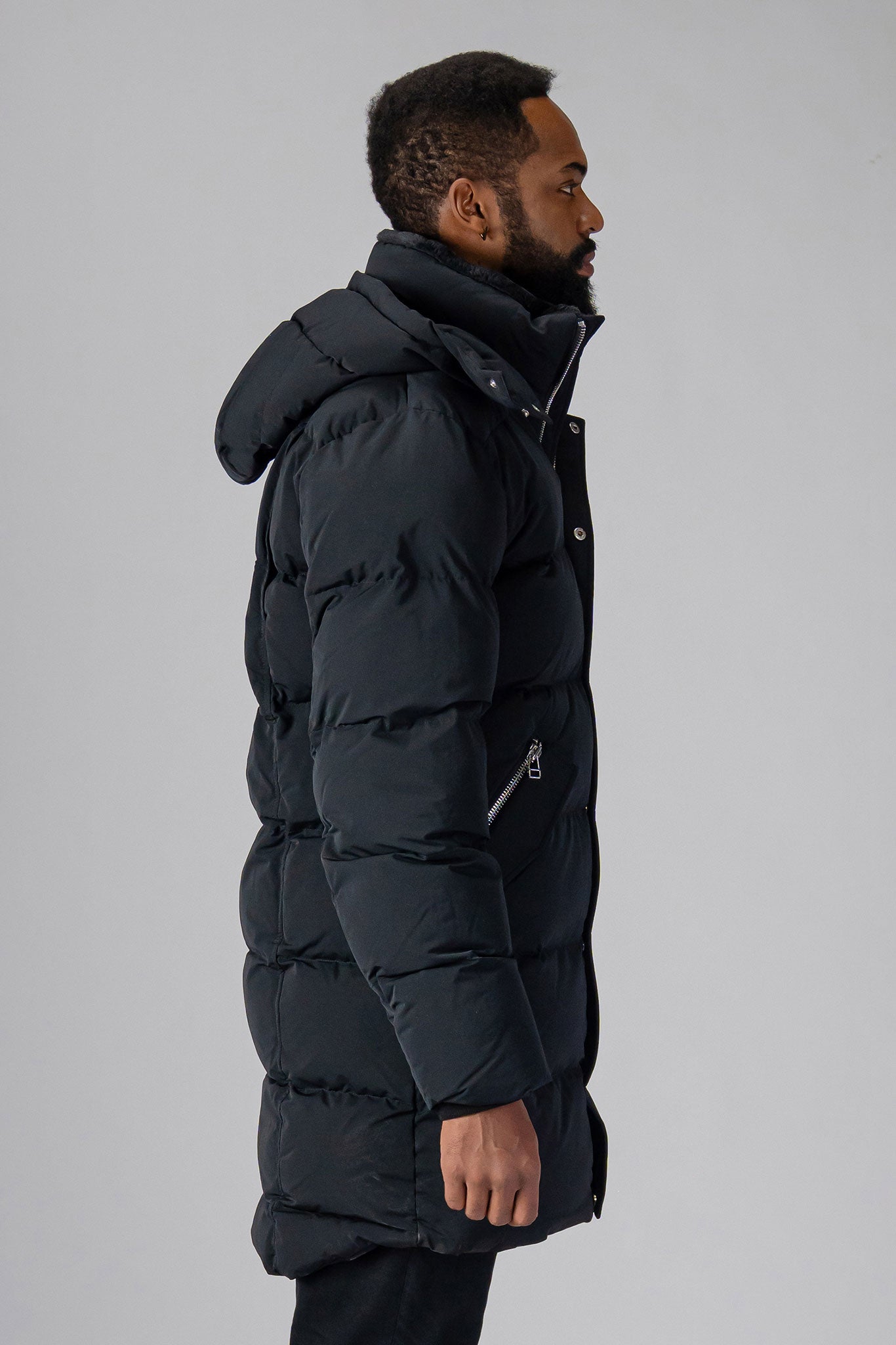 Woodpecker Men's Penguin Long Winter coat. High-end Canadian designer winter coat for men in “Matte Black” colour. Woodpecker cruelty-free winter coat designed in Canada. Men's heavy weight long length premium designer jacket for winter. Superior quality warm winter coat for men. Moose Knuckles, Canada Goose, Mackage, Montcler, Will Poho, Willbird, Nic Bayley. Extra warm. Shiny parka. Stylish winter jacket. Designer winter coat.