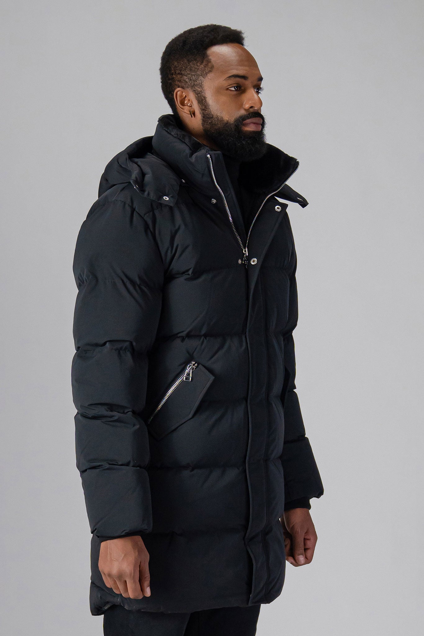 Woodpecker Men's Penguin Long Winter coat. High-end Canadian designer winter coat for men in “Matte Black” colour. Woodpecker cruelty-free winter coat designed in Canada. Men's heavy weight long length premium designer jacket for winter. Superior quality warm winter coat for men. Moose Knuckles, Canada Goose, Mackage, Montcler, Will Poho, Willbird, Nic Bayley. Extra warm. Shiny parka. Stylish winter jacket. Designer winter coat.