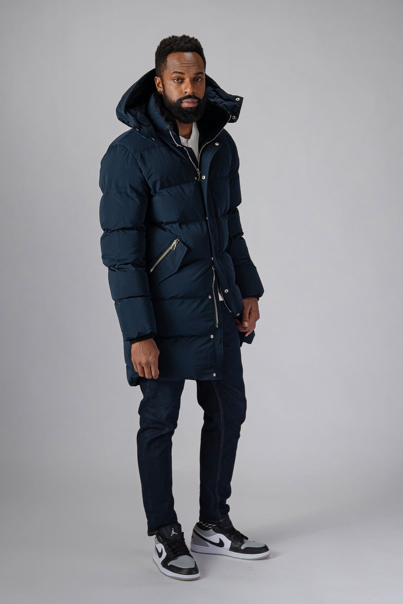 Woodpecker Men's Penguin Long Winter coat. High-end Canadian designer winter coat for men in “Matte Navy" colour. Woodpecker cruelty-free winter coat designed in Canada. Men's heavy weight long length premium designer jacket for winter. Superior quality warm winter coat for men. Moose Knuckles, Canada Goose, Mackage, Montcler, Will Poho, Willbird, Nic Bayley. Extra warm. Shiny parka. Stylish winter jacket. Designer winter coat.