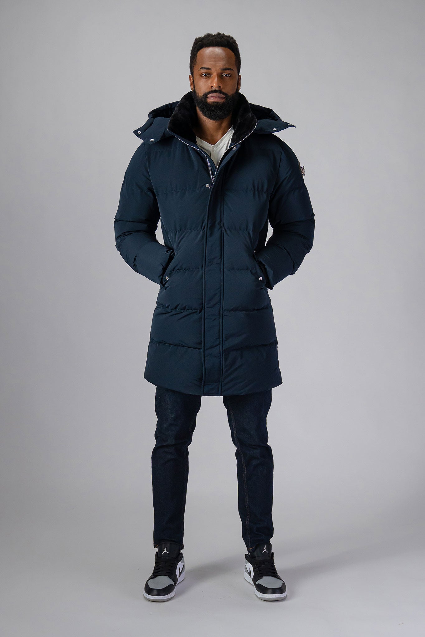 Woodpecker Men's Penguin Long Winter coat. High-end Canadian designer winter coat for men in “Matte Navy" colour. Woodpecker cruelty-free winter coat designed in Canada. Men's heavy weight long length premium designer jacket for winter. Superior quality warm winter coat for men. Moose Knuckles, Canada Goose, Mackage, Montcler, Will Poho, Willbird, Nic Bayley. Extra warm. Shiny parka. Stylish winter jacket. Designer winter coat.