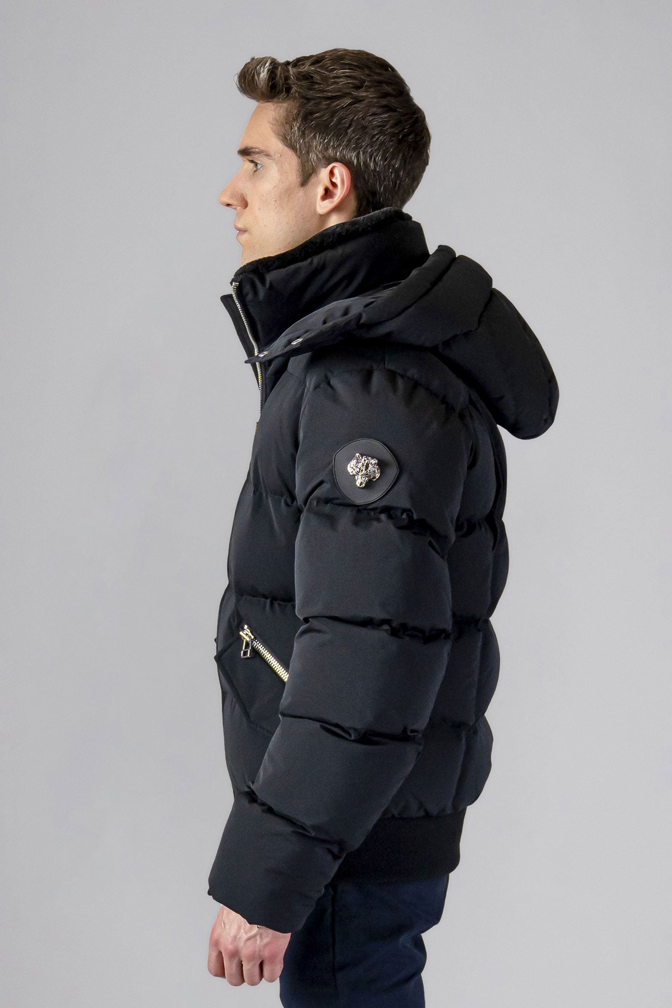 Woodpecker Men's Woody Bomber Winter coat. High-end Canadian designer winter coat for men in “Matte Black" colour. Woodpecker cruelty-free winter coat designed in Canada. Men's heavy weight short length premium designer jacket for winter. Superior quality warm winter coat for men. Moose Knuckles, Canada Goose, Mackage, Montcler, Will Poho, Willbird, Nic Bayley. Shiny parka. Stylish winter jacket. Designer winter coat.