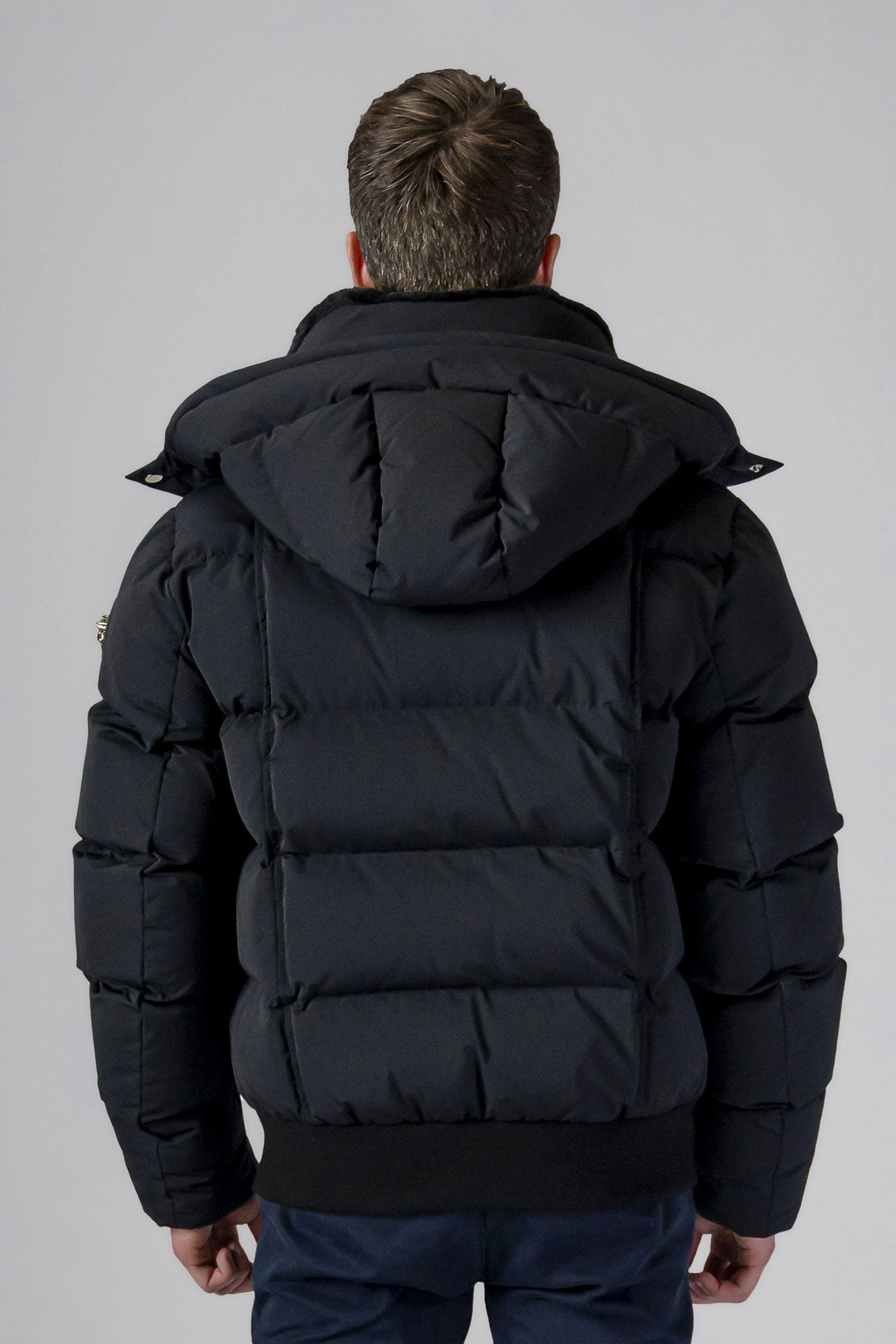 Woodpecker Men's Woody Bomber Winter coat. High-end Canadian designer winter coat for men in “Matte Black" colour. Woodpecker cruelty-free winter coat designed in Canada. Men's heavy weight short length premium designer jacket for winter. Superior quality warm winter coat for men. Moose Knuckles, Canada Goose, Mackage, Montcler, Will Poho, Willbird, Nic Bayley. Shiny parka. Stylish winter jacket. Designer winter coat.