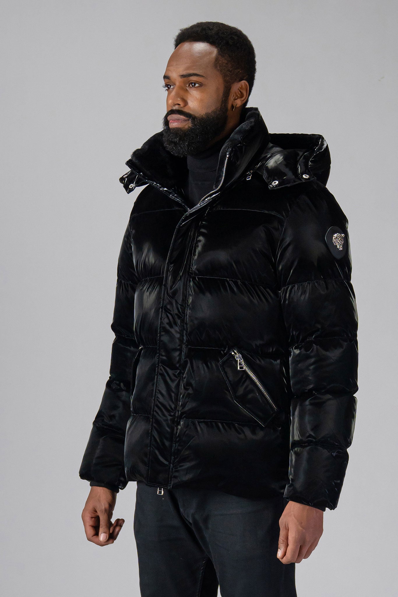 Woodpecker Men's Bumnester Winter coat. High-end Canadian designer winter coat for men in "All Wet Black" colour. Woodpecker cruelty-free winter coat designed in Canada. Men's heavy weight medium length premium designer jacket for winter. Superior quality warm winter coat for men. Moose Knuckles, Canada Goose, Mackage, Montcler, Will Poho, Willbird, Nic Bayley. Shiny parka. Stylish winter jacket. Designer winter coat.