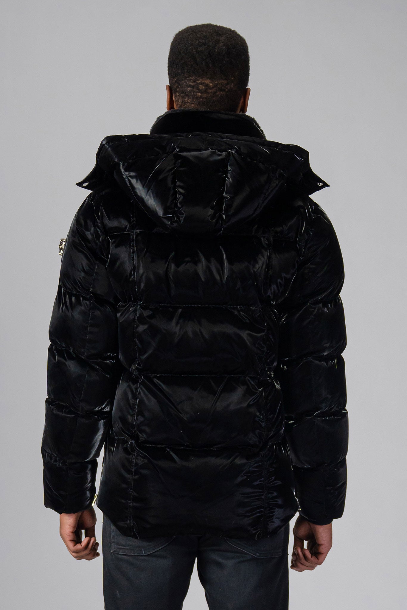 Woodpecker Men's Bumnester Winter coat. High-end Canadian designer winter coat for men in "All Wet Black" colour. Woodpecker cruelty-free winter coat designed in Canada. Men's heavy weight medium length premium designer jacket for winter. Superior quality warm winter coat for men. Moose Knuckles, Canada Goose, Mackage, Montcler, Will Poho, Willbird, Nic Bayley. Shiny parka. Stylish winter jacket. Designer winter coat.