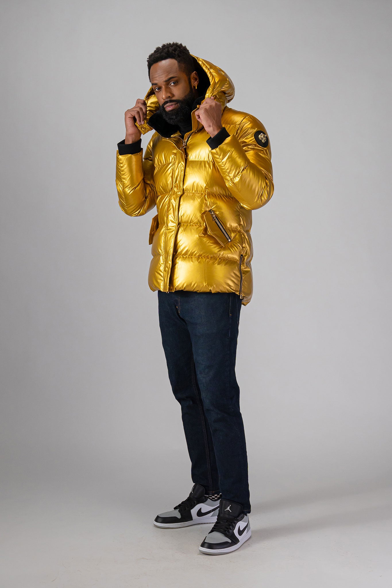 High-end Canadian designer winter coat for men in "Gold" colour. Woodpecker cruelty-free winter coat designed in Canada. Men's heavy weight medium length premium designer jacket for winter. Superior quality warm winter coat for men. Moose Knuckles, Canada Goose, Mackage, Montcler, Will Poho, Willbird, Nic Bayley. Shiny parka. Stylish winter jacket. Designer winter coat.