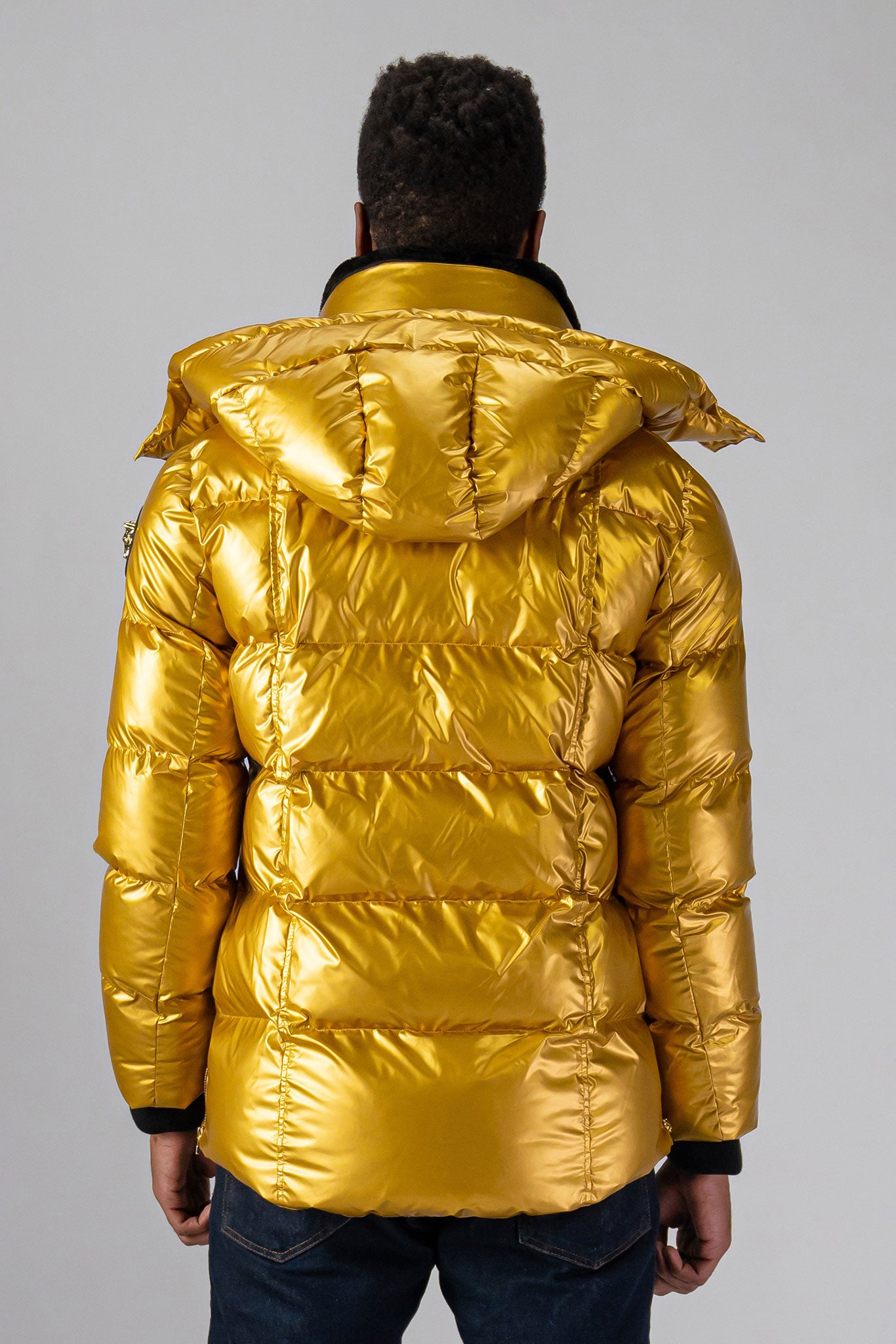 High-end Canadian designer winter coat for men in "Gold" colour. Woodpecker cruelty-free winter coat designed in Canada. Men's heavy weight medium length premium designer jacket for winter. Superior quality warm winter coat for men. Moose Knuckles, Canada Goose, Mackage, Montcler, Will Poho, Willbird, Nic Bayley. Shiny parka. Stylish winter jacket. Designer winter coat.