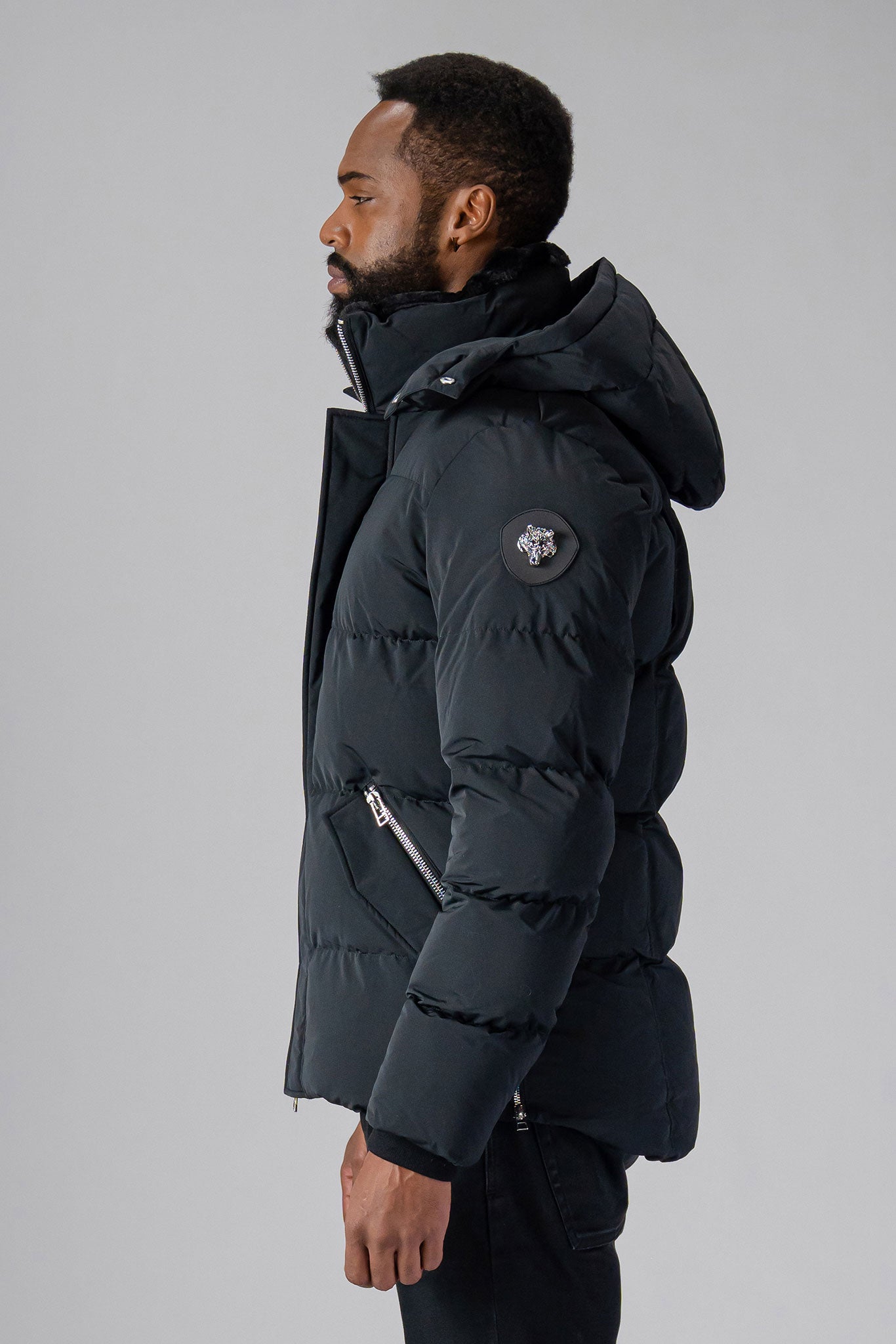 Woodpecker Men's Bumnester Winter coat. High-end Canadian designer winter coat for men in "Matte Black" colour. Woodpecker cruelty-free winter coat designed in Canada. Men's heavy weight medium length premium designer jacket for winter. Superior quality warm winter coat for men. Moose Knuckles, Canada Goose, Mackage, Montcler, Will Poho, Willbird, Nic Bayley. Shiny parka. Stylish winter jacket. Designer winter coat.