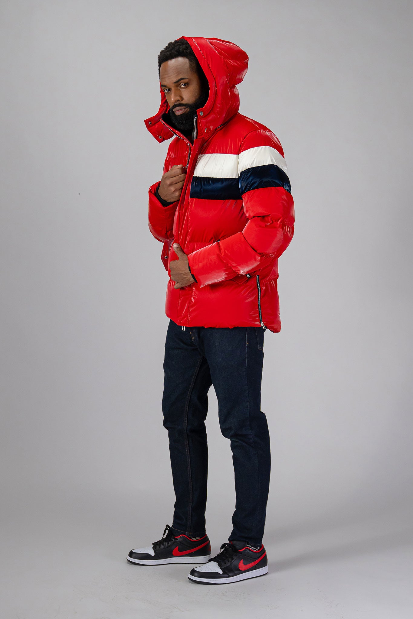 High-end Canadian designer winter coat for men in "Red White Blue" colour. Woodpecker cruelty-free winter coat designed in Canada. Men's heavy weight medium length premium designer jacket for winter. Superior quality warm winter coat for men. Moose Knuckles, Canada Goose, Mackage, Montcler, Will Poho, Willbird, Nic Bayley. Shiny parka. Stylish winter jacket. Designer winter coat.