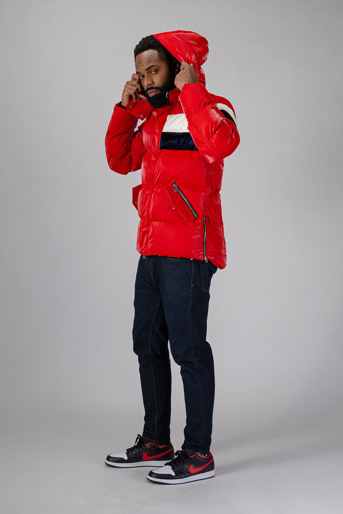 High-end Canadian designer winter coat for men in "Red White Blue" colour. Woodpecker cruelty-free winter coat designed in Canada. Men's heavy weight medium length premium designer jacket for winter. Superior quality warm winter coat for men. Moose Knuckles, Canada Goose, Mackage, Montcler, Will Poho, Willbird, Nic Bayley. Shiny parka. Stylish winter jacket. Designer winter coat.