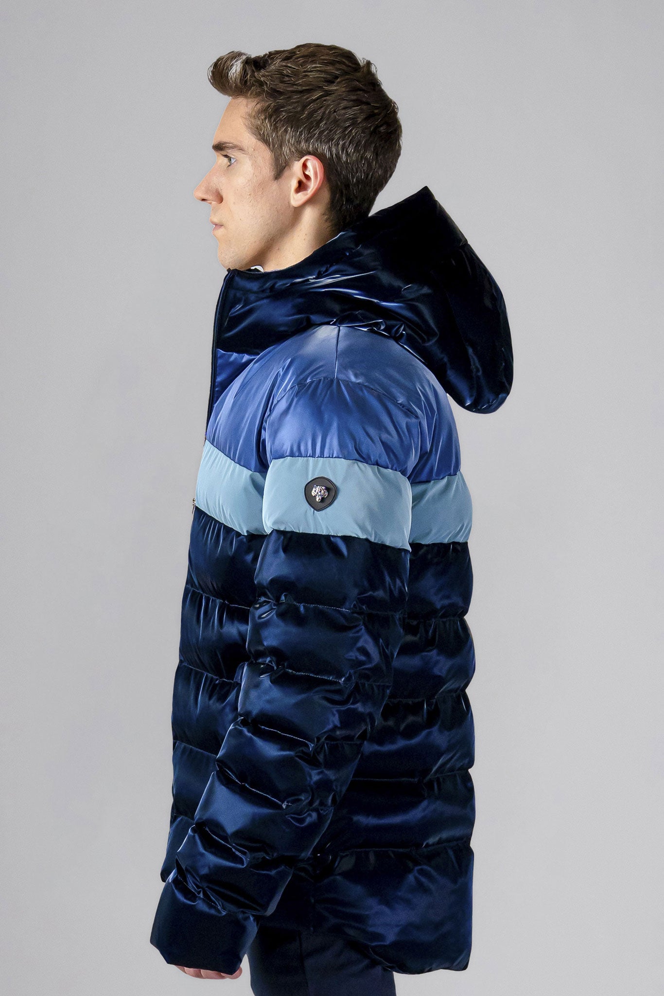 Woodpecker Men's Sparrow Winter coat. High-end Canadian designer winter coat for men in "Blue Steel" colour. Woodpecker cruelty-free winter coat designed in Canada. Men's medium weight medium length premium designer jacket for winter. Superior quality warm winter coat for men. Moose Knuckles, Canada Goose, Mackage, Montcler, Will Poho, Willbird, Nic Bayley. Shiny parka. Stylish winter jacket. Designer winter coat.