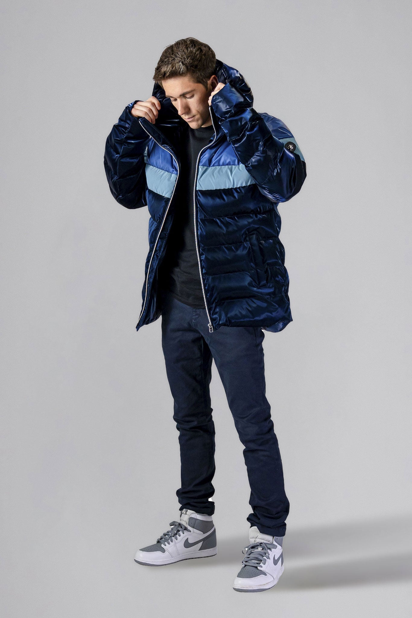 Woodpecker Men's Sparrow Winter coat. High-end Canadian designer winter coat for men in "Blue Steel" colour. Woodpecker cruelty-free winter coat designed in Canada. Men's medium weight medium length premium designer jacket for winter. Superior quality warm winter coat for men. Moose Knuckles, Canada Goose, Mackage, Montcler, Will Poho, Willbird, Nic Bayley. Shiny parka. Stylish winter jacket. Designer winter coat.