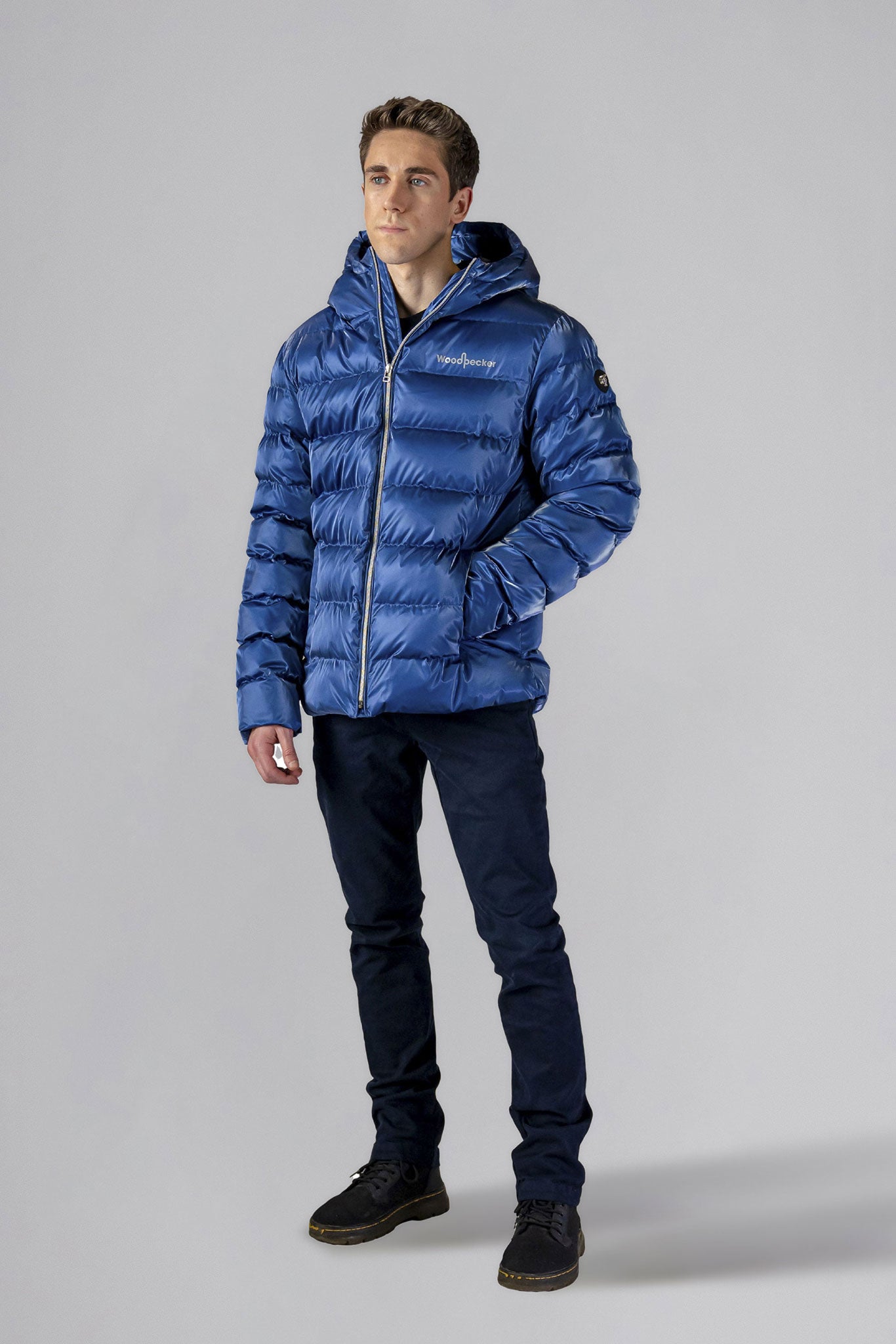 High-end Canadian designer winter coat for men in "Flash Blue" colour. Woodpecker cruelty-free winter coat designed in Canada. Men's medium weight medium length premium designer jacket for winter. Superior quality warm winter coat for men. Moose Knuckles, Canada Goose, Mackage, Montcler, Will Poho, Willbird, Nic Bayley. Shiny parka. Stylish winter jacket. Designer winter coat.