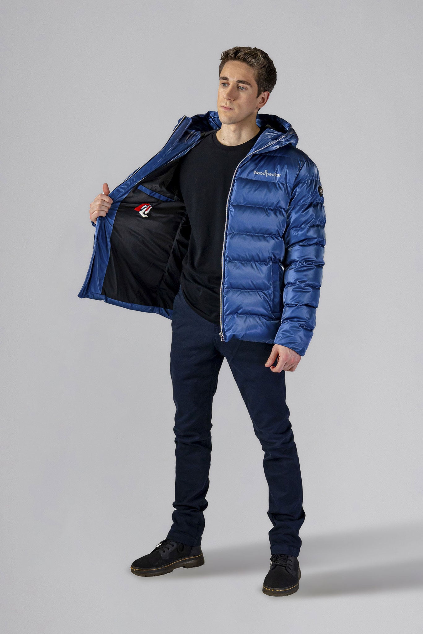 High-end Canadian designer winter coat for men in "Flash Blue" colour. Woodpecker cruelty-free winter coat designed in Canada. Men's medium weight medium length premium designer jacket for winter. Superior quality warm winter coat for men. Moose Knuckles, Canada Goose, Mackage, Montcler, Will Poho, Willbird, Nic Bayley. Shiny parka. Stylish winter jacket. Designer winter coat.