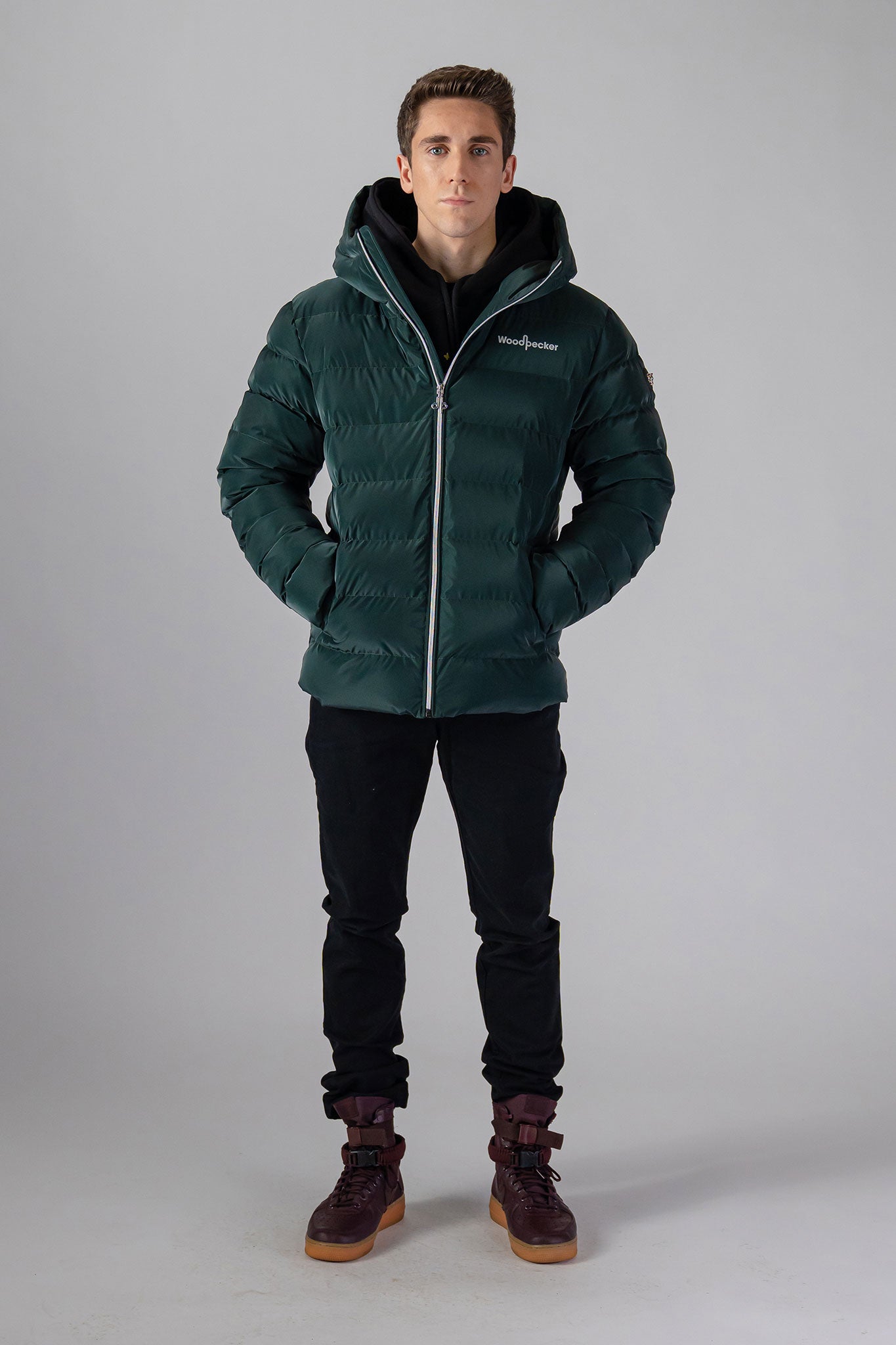 Woodpecker Men's Sparrow Winter coat. High-end Canadian designer winter coat for men in "Green Diamond" colour. Woodpecker cruelty-free winter coat designed in Canada. Men's medium weight medium length premium designer jacket for winter. Superior quality warm winter coat for men. Moose Knuckles, Canada Goose, Mackage, Montcler, Will Poho, Willbird, Nic Bayley. Shiny parka. Stylish winter jacket. Designer winter coat.