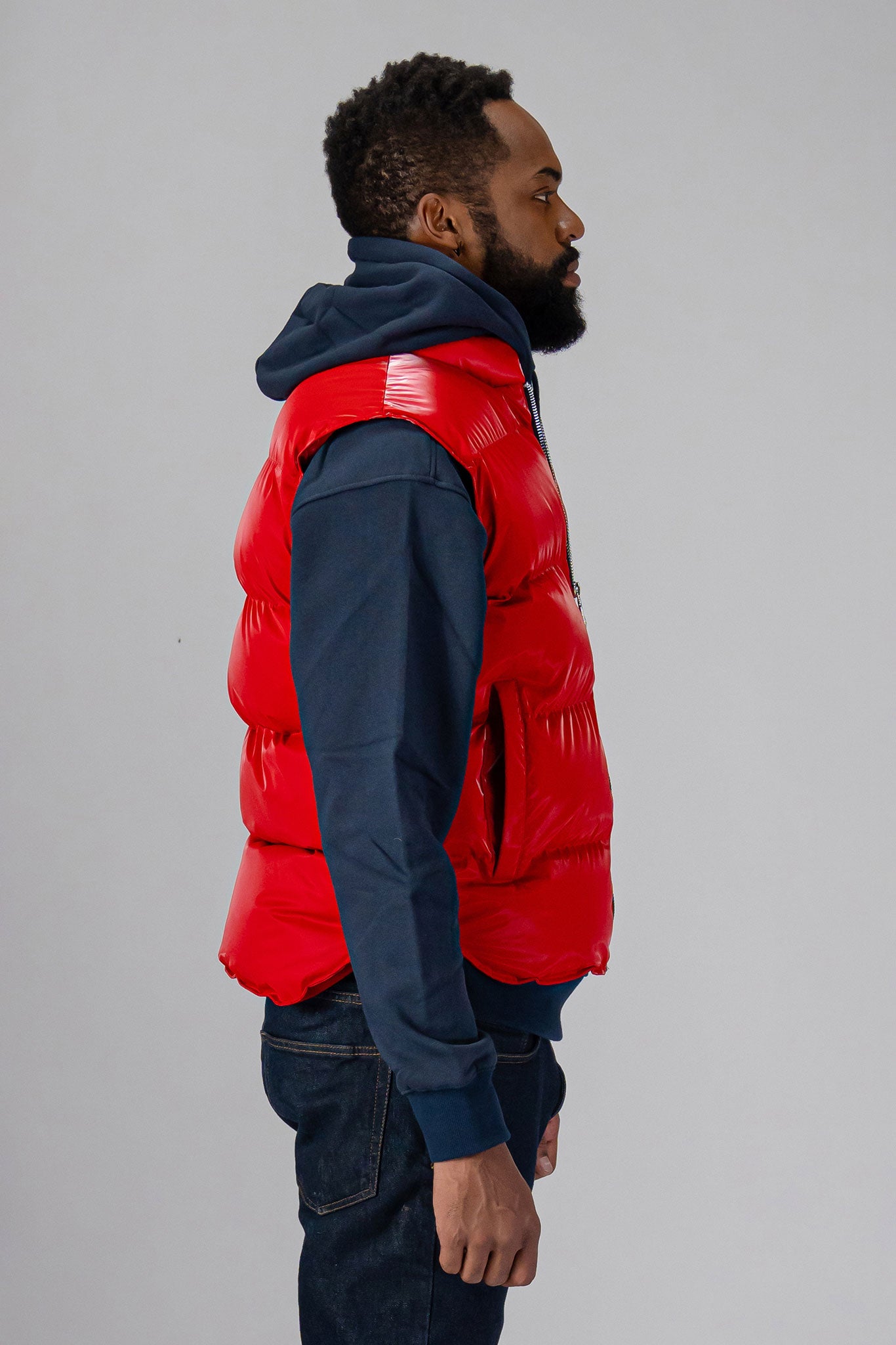 Woodpecker Unisex Winter Vest. High-end Canadian designer winter vest in "Fashion Santa" red colour. Woodpecker cruelty-free vest designed in Canada. Heavy weight short length premium designer vest for winter. Superior quality warm winter vest. Moose Knuckles, Canada Goose, Mackage, Montcler, Will Poho, Willbird, Nic Bayley. Extra warm. Shiny vest. Stylish winter vest. Designer winter vest.