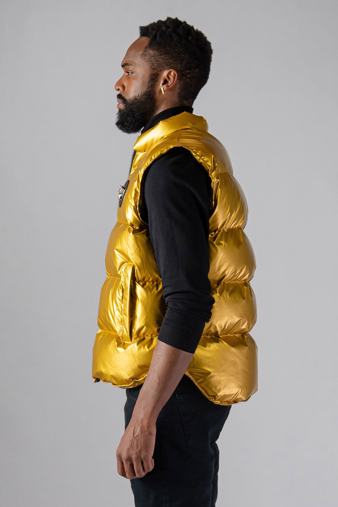 Woodpecker Unisex Winter Vest. High-end Canadian designer winter vest in "Gold" colour. Woodpecker cruelty-free vest designed in Canada. Heavy weight short length premium designer vest for winter. Superior quality warm winter vest. Moose Knuckles, Canada Goose, Mackage, Montcler, Will Poho, Willbird, Nic Bayley. Extra warm. Shiny vest. Stylish winter vest. Designer winter vest.