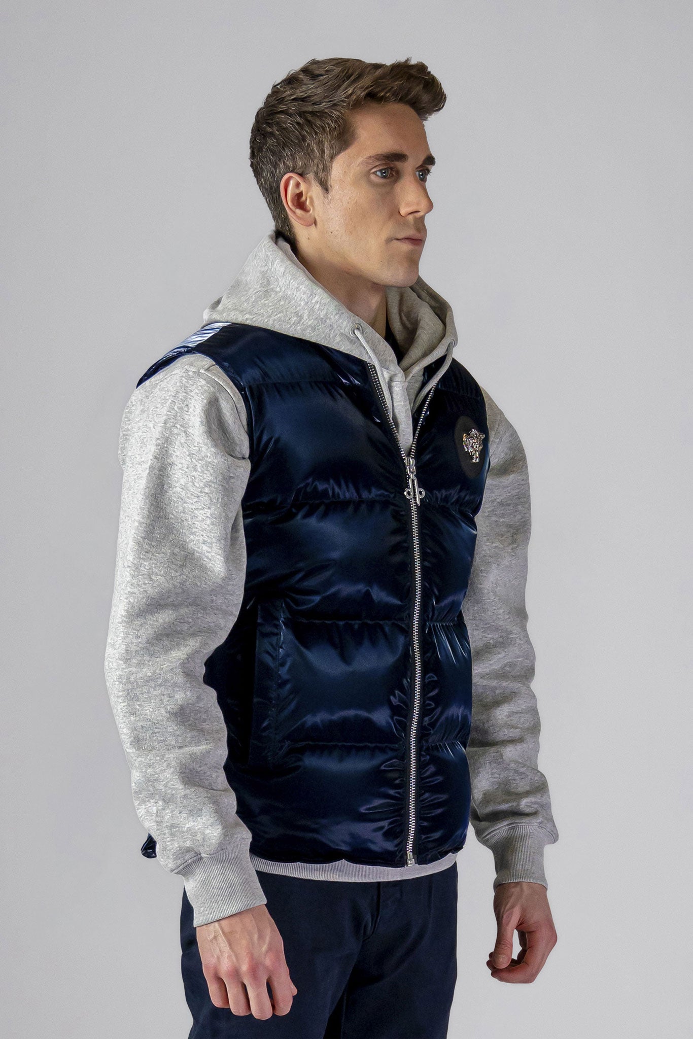 Woodpecker Unisex Winter Vest. High-end Canadian designer winter vest in "All Wet Navy" colour. Woodpecker cruelty-free vest designed in Canada. Heavy weight short length premium designer vest for winter. Superior quality warm winter vest. Moose Knuckles, Canada Goose, Mackage, Montcler, Will Poho, Willbird, Nic Bayley. Extra warm. Shiny vest. Stylish winter vest. Designer winter vest.