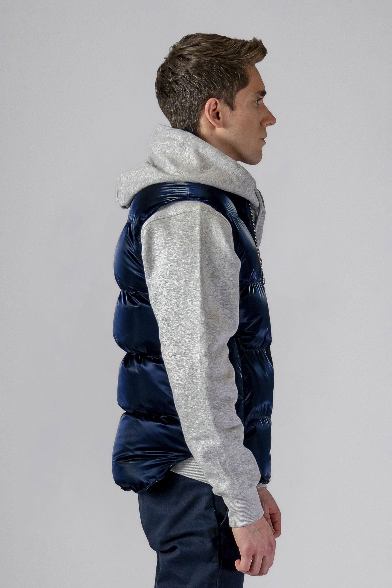 Woodpecker Unisex Winter Vest. High-end Canadian designer winter vest in "All Wet Navy" colour. Woodpecker cruelty-free vest designed in Canada. Heavy weight short length premium designer vest for winter. Superior quality warm winter vest. Moose Knuckles, Canada Goose, Mackage, Montcler, Will Poho, Willbird, Nic Bayley. Extra warm. Shiny vest. Stylish winter vest. Designer winter vest.