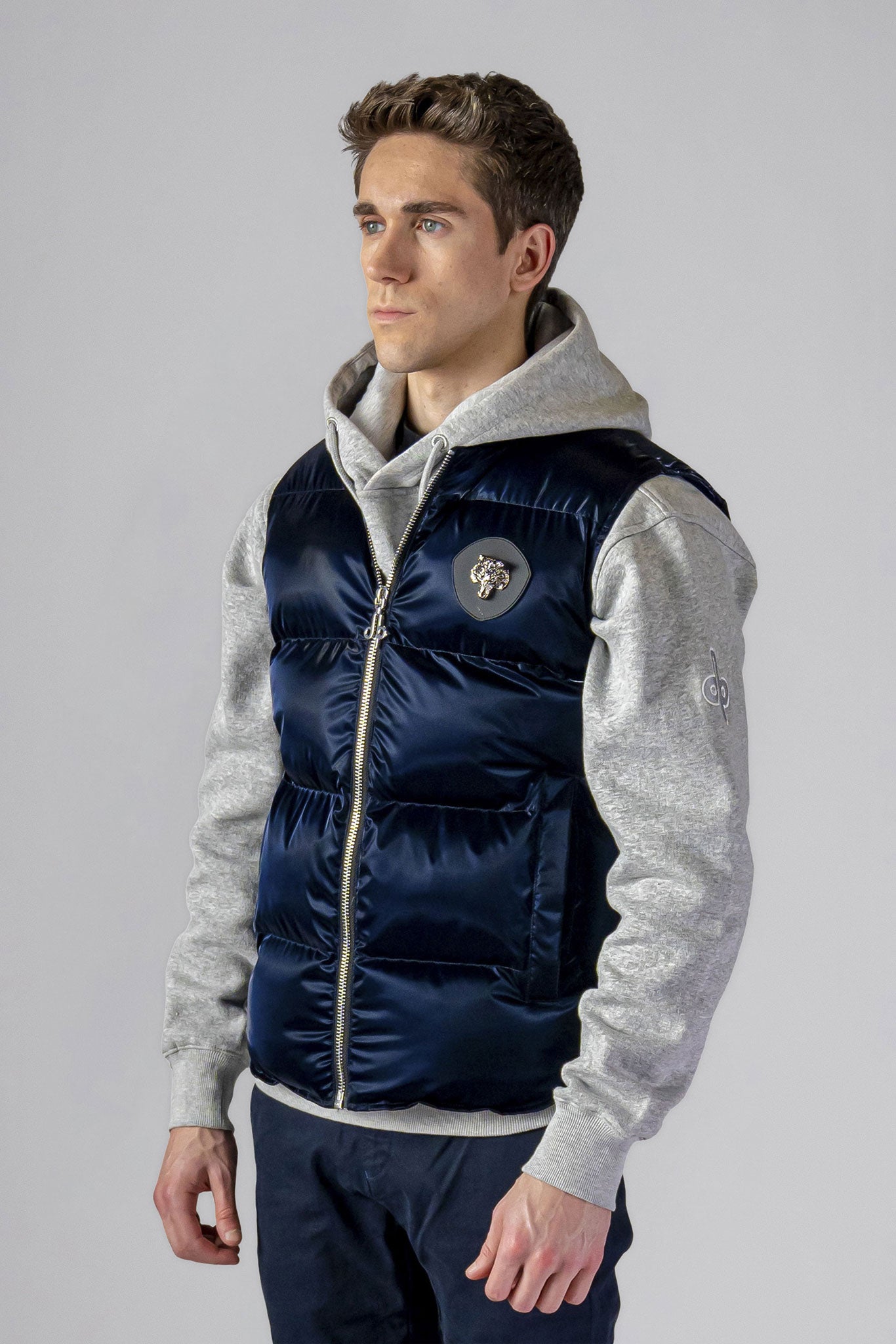 Woodpecker Unisex Winter Vest. High-end Canadian designer winter vest in "All Wet Navy" colour. Woodpecker cruelty-free vest designed in Canada. Heavy weight short length premium designer vest for winter. Superior quality warm winter vest. Moose Knuckles, Canada Goose, Mackage, Montcler, Will Poho, Willbird, Nic Bayley. Extra warm. Shiny vest. Stylish winter vest. Designer winter vest.