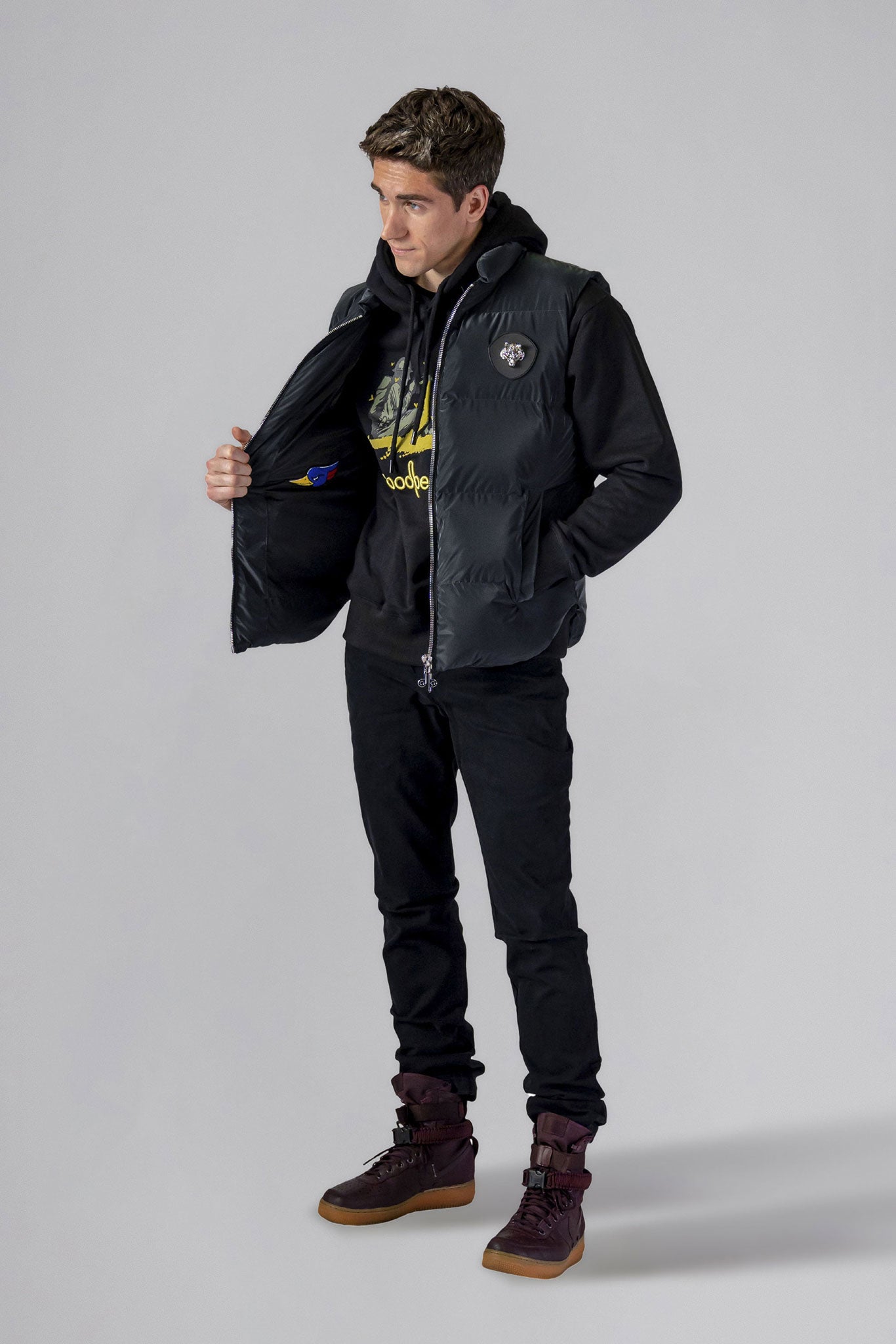 Woodpecker Unisex Winter Vest. High-end Canadian designer winter vest in "Black Diamond" colour. Woodpecker cruelty-free vest designed in Canada. Heavy weight short length premium designer vest for winter. Superior quality warm winter vest. Moose Knuckles, Canada Goose, Mackage, Montcler, Will Poho, Willbird, Nic Bayley. Extra warm. Shiny vest. Stylish winter vest. Designer winter vest.