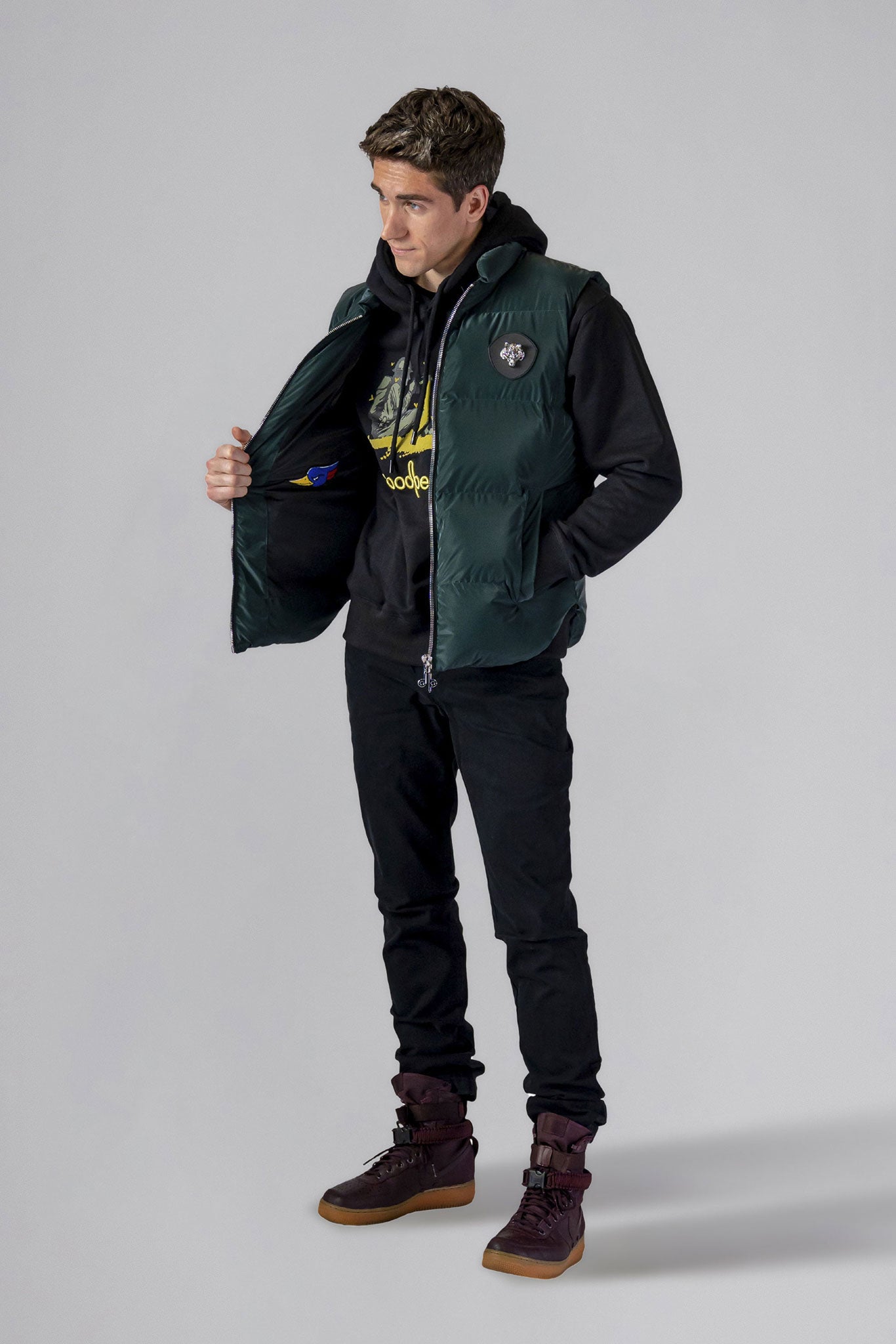 Woodpecker Unisex Winter Vest. High-end Canadian designer winter vest in "Green Diamond" colour. Woodpecker cruelty-free vest designed in Canada. Heavy weight short length premium designer vest for winter. Superior quality warm winter vest. Moose Knuckles, Canada Goose, Mackage, Montcler, Will Poho, Willbird, Nic Bayley. Extra warm. Shiny vest. Stylish winter vest. Designer winter vest.