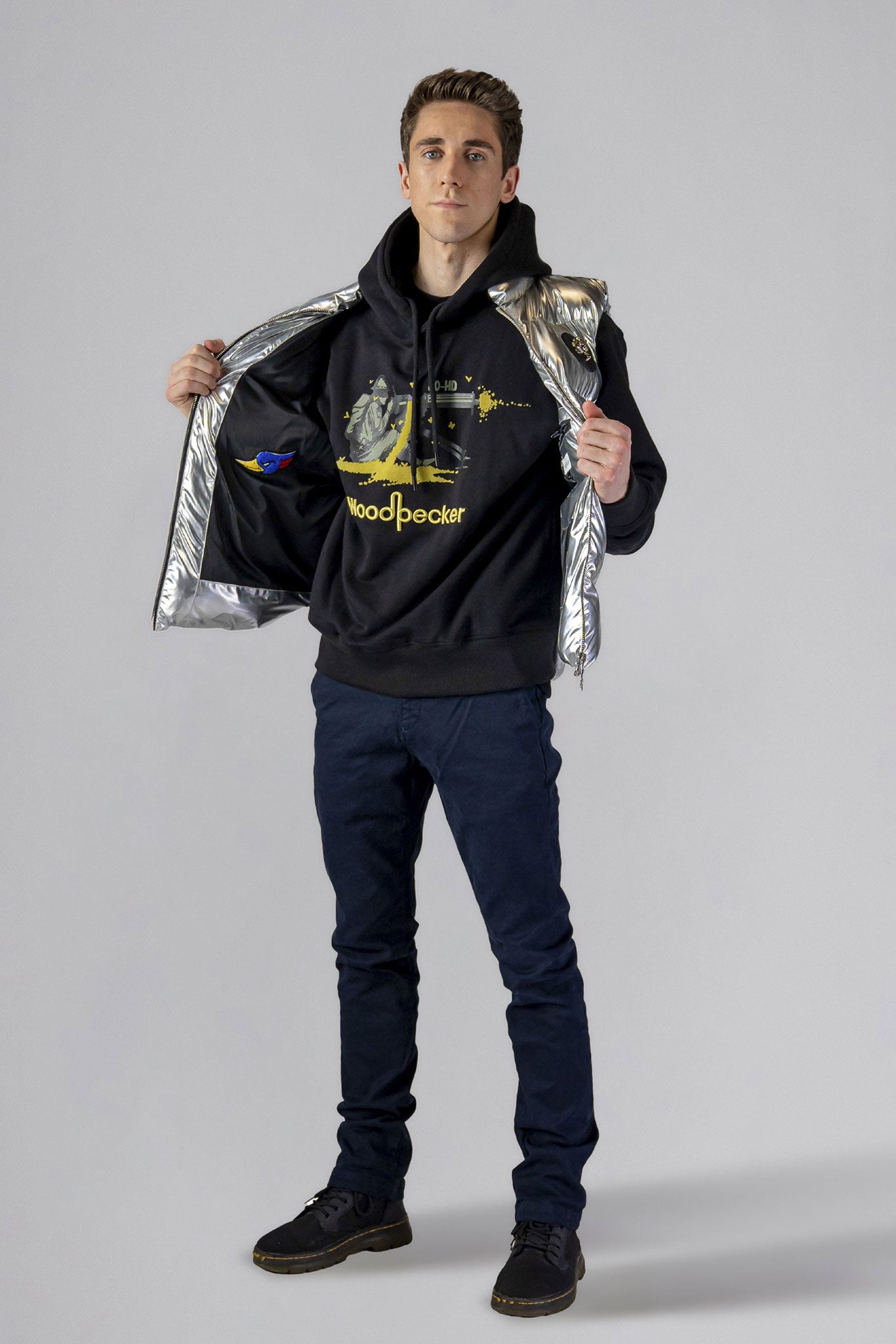 Woodpecker Unisex Winter Vest. High-end Canadian designer winter vest in "Silver" colour. Woodpecker cruelty-free vest designed in Canada. Heavy weight short length premium designer vest for winter. Superior quality warm winter vest. Moose Knuckles, Canada Goose, Mackage, Montcler, Will Poho, Willbird, Nic Bayley. Extra warm. Shiny vest. Stylish winter vest. Designer winter vest.