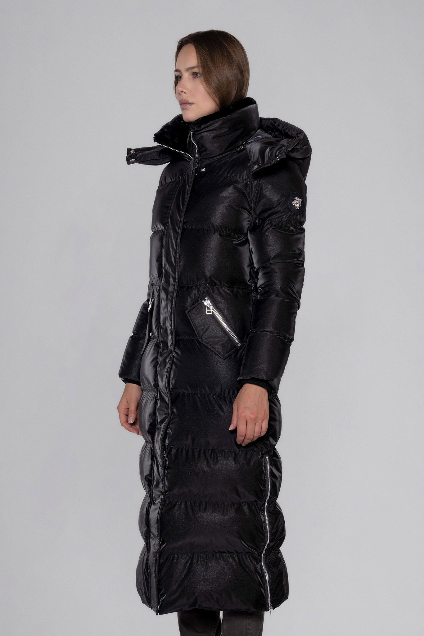 Woodpecker Women's Extra Long Bird of Paradise Winter coat. High-end Canadian designer winter coat for women in “Black Diamond" colour. Woodpecker cruelty-free winter coat designed in Canada. Women's heavy weight extra long length premium designer jacket for winter. Superior quality warm winter coat for women. Moose Knuckles, Canada Goose, Mackage, Montcler, Will Poho, Willbird, Nic Bayley. Extra warm. Shiny parka. Stylish winter jacket. Designer winter coat.