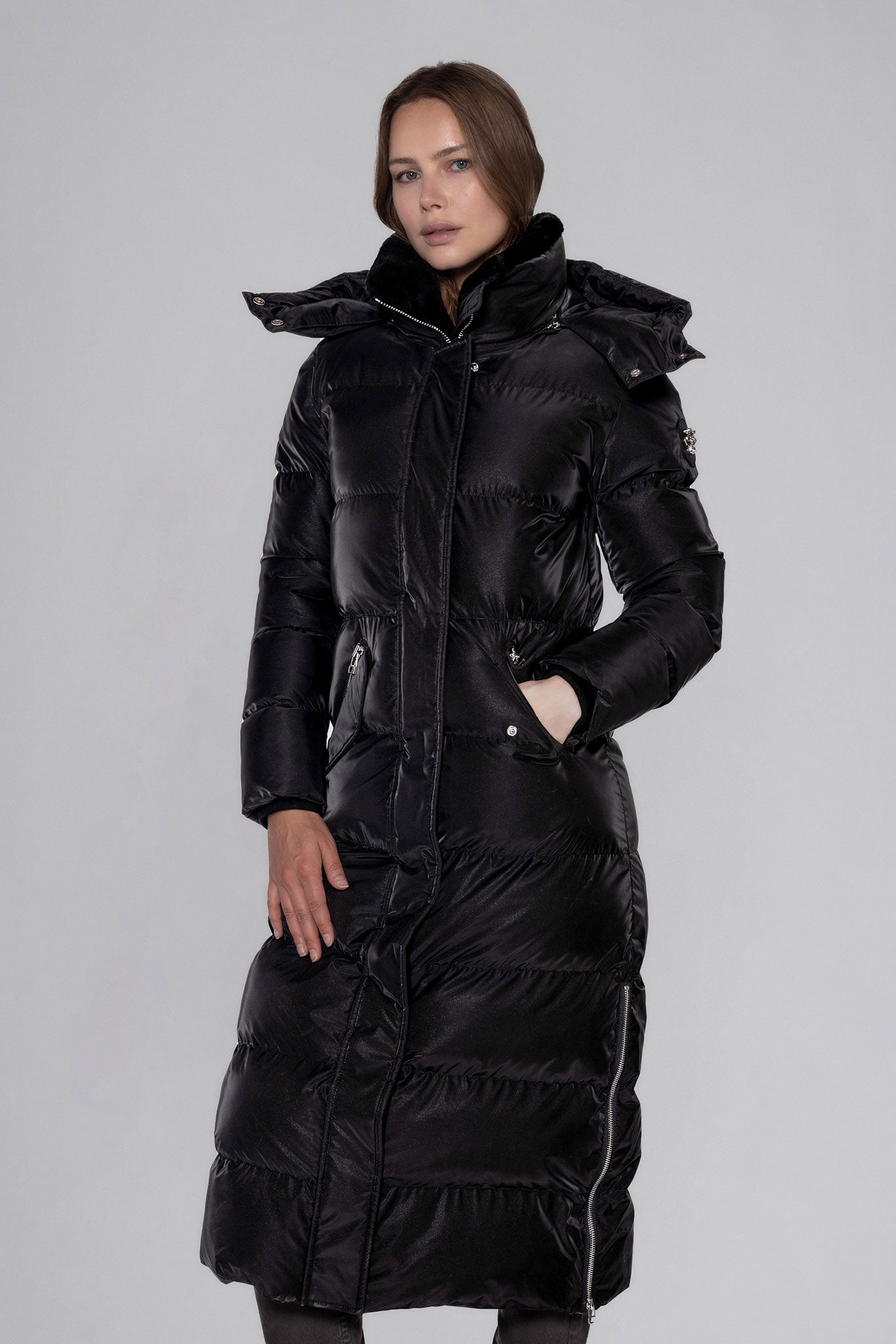 Woodpecker Women's Extra Long Bird of Paradise Winter coat. High-end Canadian designer winter coat for women in “Black Diamond" colour. Woodpecker cruelty-free winter coat designed in Canada. Women's heavy weight extra long length premium designer jacket for winter. Superior quality warm winter coat for women. Moose Knuckles, Canada Goose, Mackage, Montcler, Will Poho, Willbird, Nic Bayley. Extra warm. Shiny parka. Stylish winter jacket. Designer winter coat.