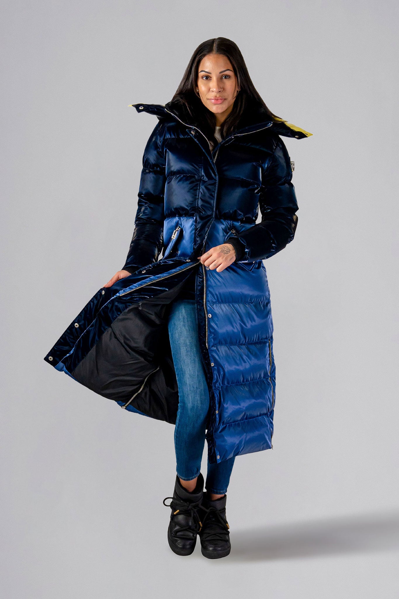 Woodpecker Women's Extra Long Bird of Paradise Winter coat. High-end Canadian designer winter coat for women in “Blue Yellow" colour. Woodpecker cruelty-free winter coat designed in Canada. Women's heavy weight extra long length premium designer jacket for winter. Superior quality warm winter coat for women. Moose Knuckles, Canada Goose, Mackage, Montcler, Will Poho, Willbird, Nic Bayley. Extra warm. Shiny parka. Stylish winter jacket. Designer winter coat.