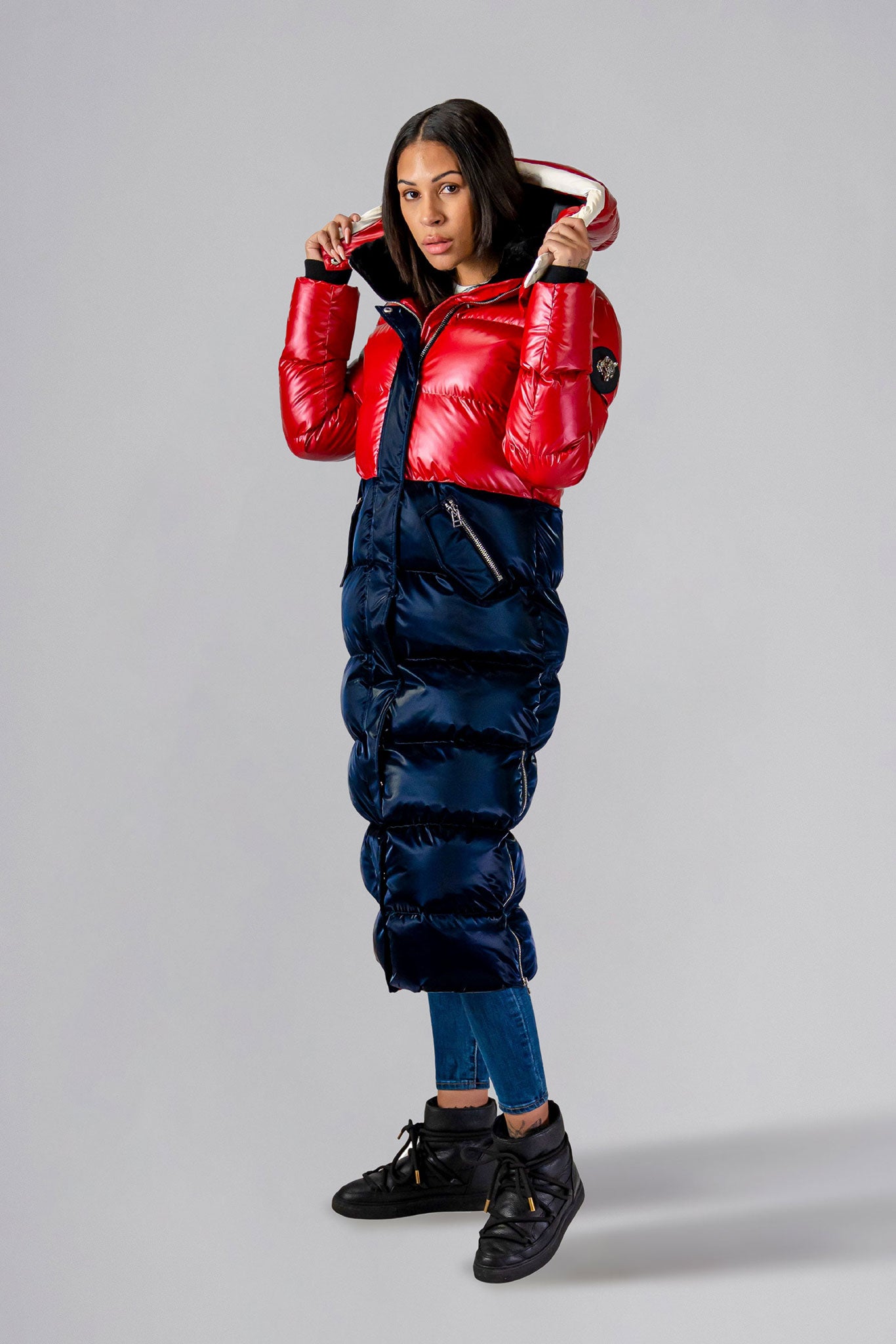 Woodpecker Women's Extra Long Bird of Paradise Winter coat. High-end Canadian designer winter coat for women in “Red White and Blue" colour. Woodpecker cruelty-free winter coat designed in Canada. Women's heavy weight extra long length premium designer jacket for winter. Superior quality warm winter coat for women. Moose Knuckles, Canada Goose, Mackage, Montcler, Will Poho, Willbird, Nic Bayley. Extra warm. Shiny parka. Stylish winter jacket. Designer winter coat.