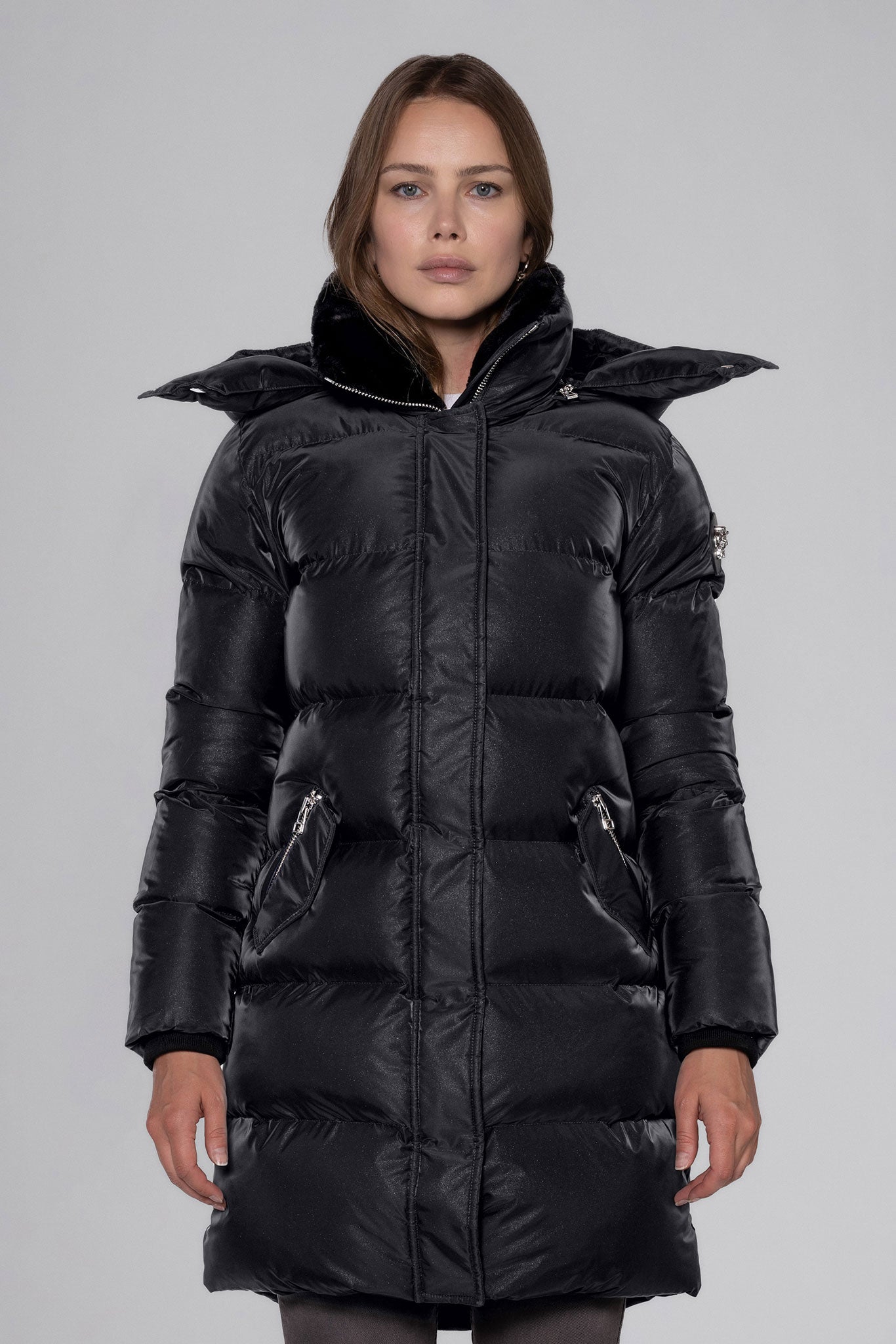 Woodpecker Women's Penguin Long Winter coat. High-end Canadian designer winter coat for women in "Black Diamond" colour. Woodpecker cruelty-free winter coat designed in Canada. Women's heavy weight long length premium designer jacket for winter. Superior quality warm winter coat for women. Moose Knuckles, Canada Goose, Mackage, Montcler, Will Poho, Willbird, Nic Bayley. Extra warm. Shiny parka. Stylish winter jacket. Designer winter coat.