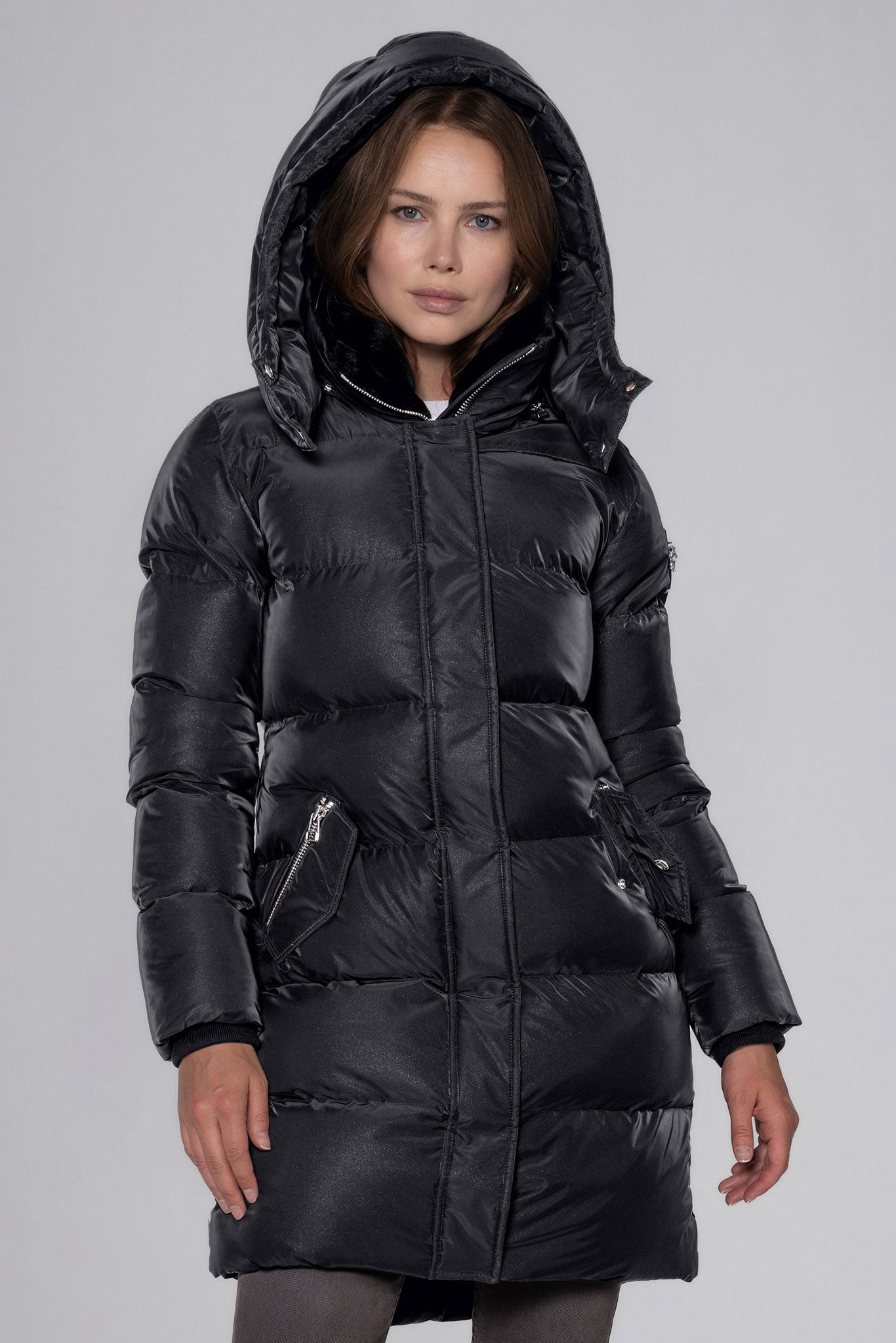 Woodpecker Women's Penguin Long Winter coat. High-end Canadian designer winter coat for women in "Black Diamond" colour. Woodpecker cruelty-free winter coat designed in Canada. Women's heavy weight long length premium designer jacket for winter. Superior quality warm winter coat for women. Moose Knuckles, Canada Goose, Mackage, Montcler, Will Poho, Willbird, Nic Bayley. Extra warm. Shiny parka. Stylish winter jacket. Designer winter coat.