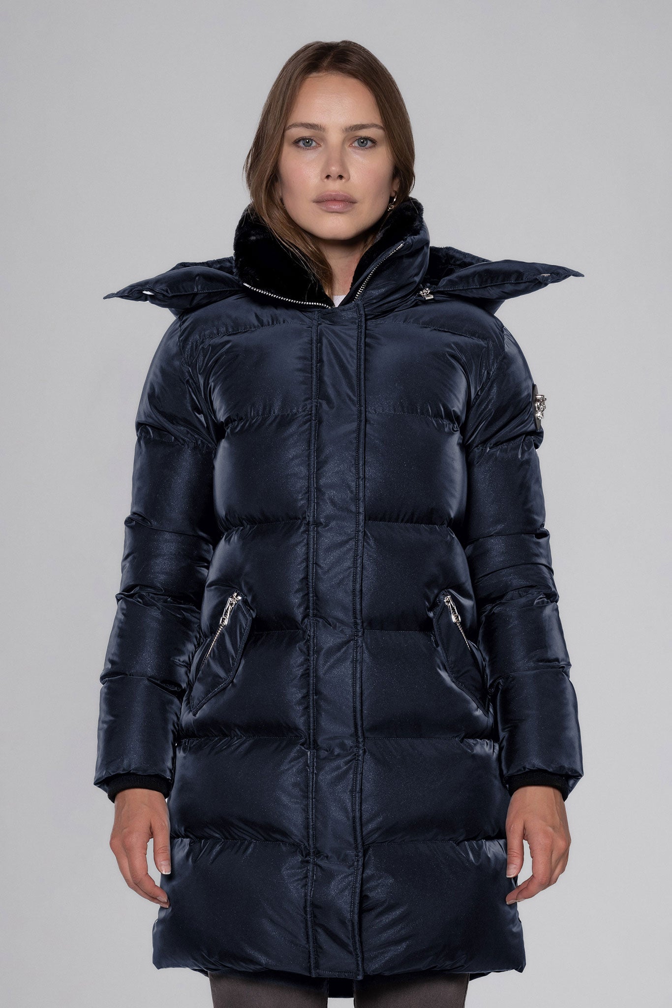 Woodpecker Women's Penguin Long Winter coat. High-end Canadian designer winter coat for women in "Blue Diamond" colour. Woodpecker cruelty-free winter coat designed in Canada. Women's heavy weight long length premium designer jacket for winter. Superior quality warm winter coat for women. Moose Knuckles, Canada Goose, Mackage, Montcler, Will Poho, Willbird, Nic Bayley. Extra warm. Shiny parka. Stylish winter jacket. Designer winter coat.