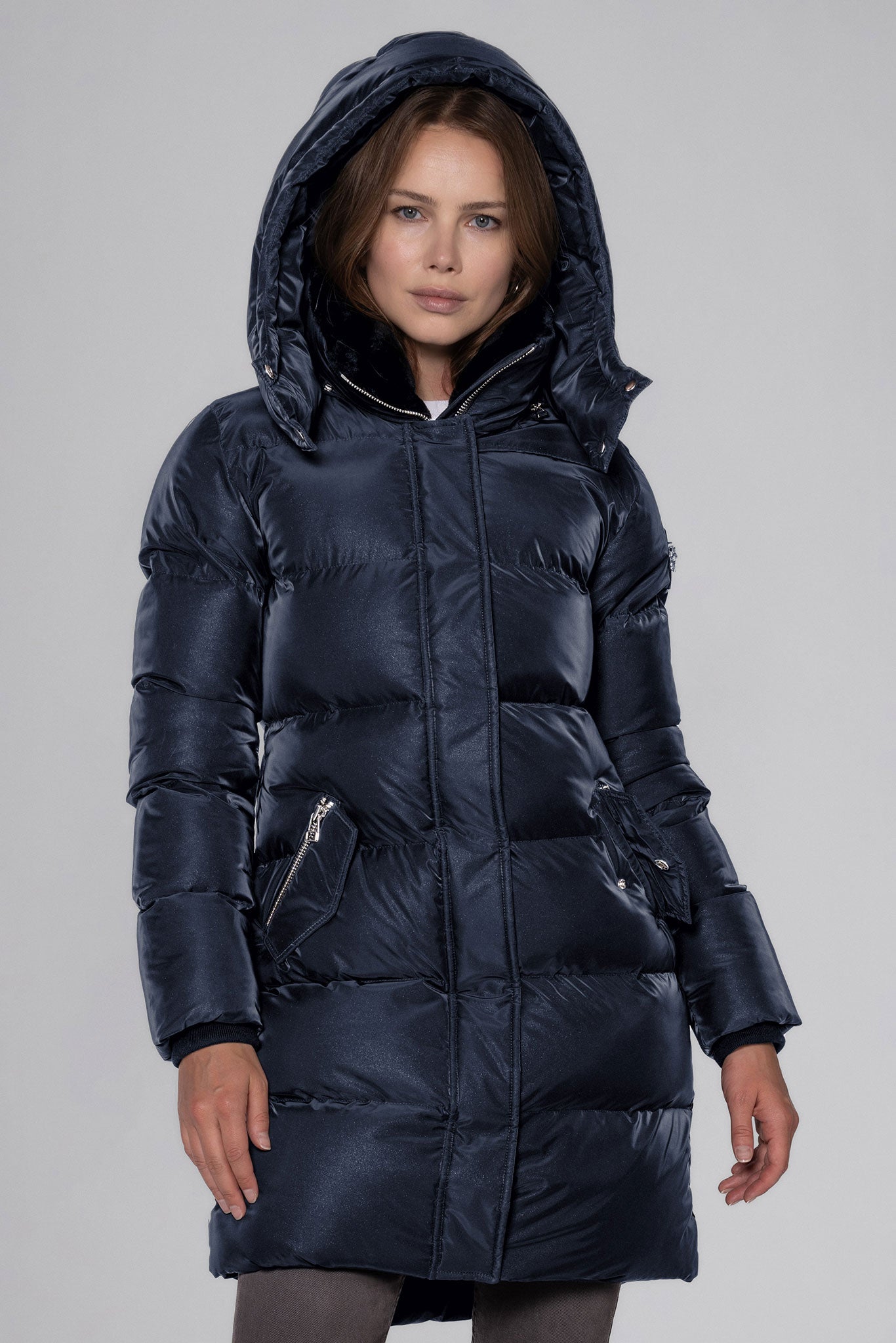 Woodpecker Women's Penguin Long Winter coat. High-end Canadian designer winter coat for women in "Blue Diamond" colour. Woodpecker cruelty-free winter coat designed in Canada. Women's heavy weight long length premium designer jacket for winter. Superior quality warm winter coat for women. Moose Knuckles, Canada Goose, Mackage, Montcler, Will Poho, Willbird, Nic Bayley. Extra warm. Shiny parka. Stylish winter jacket. Designer winter coat.