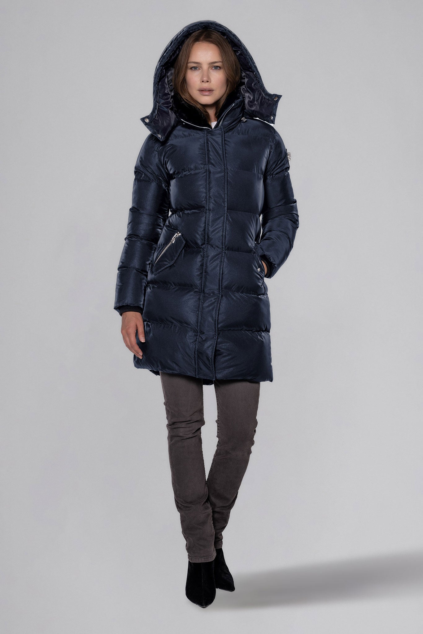 Woodpecker Women's Penguin Long Winter coat. High-end Canadian designer winter coat for women in "Blue Diamond" colour. Woodpecker cruelty-free winter coat designed in Canada. Women's heavy weight long length premium designer jacket for winter. Superior quality warm winter coat for women. Moose Knuckles, Canada Goose, Mackage, Montcler, Will Poho, Willbird, Nic Bayley. Extra warm. Shiny parka. Stylish winter jacket. Designer winter coat.