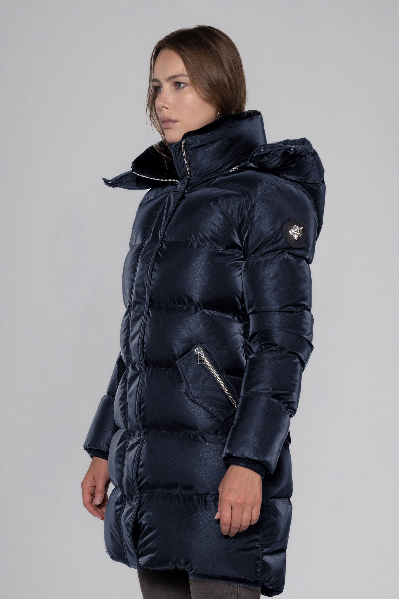 Woodpecker Women's Penguin Long Winter coat. High-end Canadian designer winter coat for women in "Blue Diamond" colour. Woodpecker cruelty-free winter coat designed in Canada. Women's heavy weight long length premium designer jacket for winter. Superior quality warm winter coat for women. Moose Knuckles, Canada Goose, Mackage, Montcler, Will Poho, Willbird, Nic Bayley. Extra warm. Shiny parka. Stylish winter jacket. Designer winter coat.