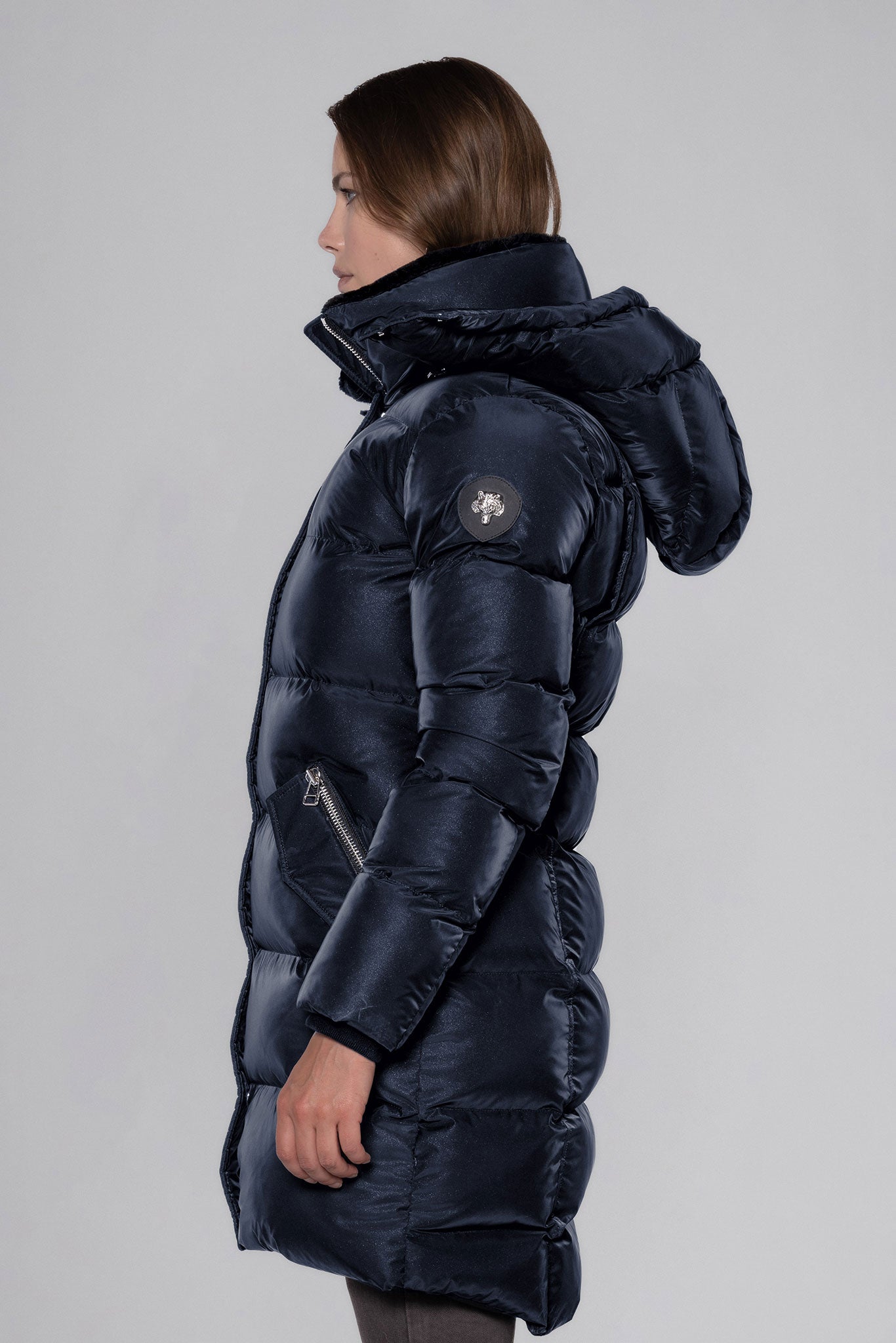 Woodpecker Women's Penguin Long Winter coat. High-end Canadian designer winter coat for women in "Blue Diamond" colour. Woodpecker cruelty-free winter coat designed in Canada. Women's heavy weight long length premium designer jacket for winter. Superior quality warm winter coat for women. Moose Knuckles, Canada Goose, Mackage, Montcler, Will Poho, Willbird, Nic Bayley. Extra warm. Shiny parka. Stylish winter jacket. Designer winter coat.