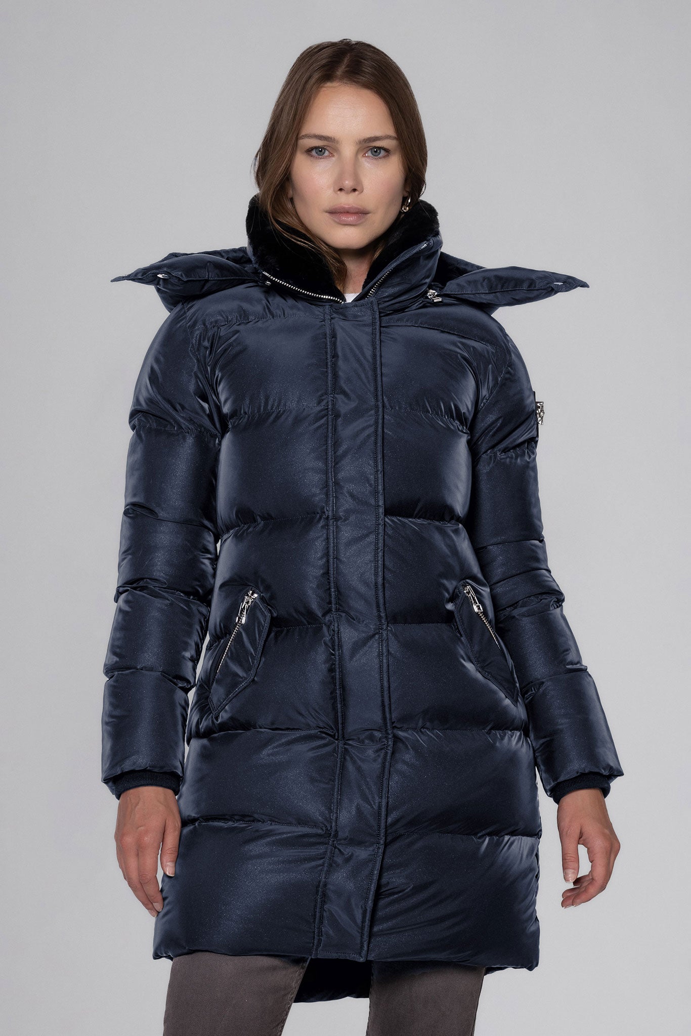 Woodpecker Women's Penguin Long Winter coat. High-end Canadian designer winter coat for women in "Blue Diamond" colour. Woodpecker cruelty-free winter coat designed in Canada. Women's heavy weight long length premium designer jacket for winter. Superior quality warm winter coat for women. Moose Knuckles, Canada Goose, Mackage, Montcler, Will Poho, Willbird, Nic Bayley. Extra warm. Shiny parka. Stylish winter jacket. Designer winter coat.