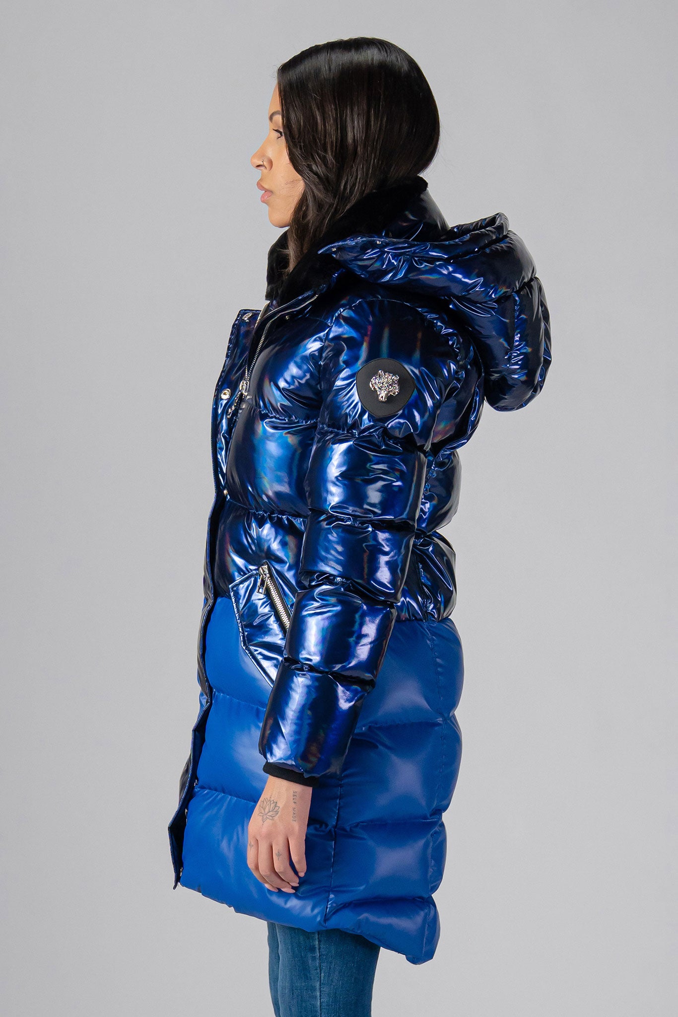 Woodpecker Women's Penguin Long Winter coat. High-end Canadian designer winter coat for women in "Oily Blue Blue" colour. Woodpecker cruelty-free winter coat designed in Canada. Women's heavy weight long length premium designer jacket for winter. Superior quality warm winter coat for women. Moose Knuckles, Canada Goose, Mackage, Montcler, Will Poho, Willbird, Nic Bayley. Extra warm. Shiny parka. Stylish winter jacket. Designer winter coat.