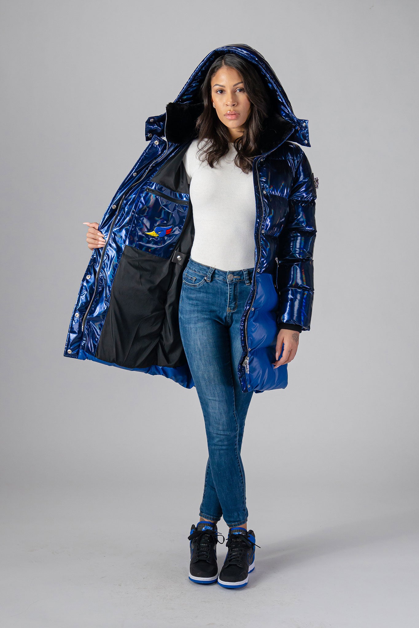 Woodpecker Women's Penguin Long Winter coat. High-end Canadian designer winter coat for women in "Oily Blue Blue" colour. Woodpecker cruelty-free winter coat designed in Canada. Women's heavy weight long length premium designer jacket for winter. Superior quality warm winter coat for women. Moose Knuckles, Canada Goose, Mackage, Montcler, Will Poho, Willbird, Nic Bayley. Extra warm. Shiny parka. Stylish winter jacket. Designer winter coat.