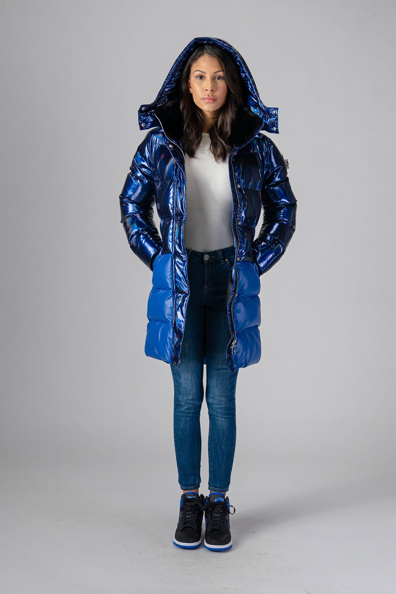 Woodpecker Women's Penguin Long Winter coat. High-end Canadian designer winter coat for women in "Oily Blue Blue" colour. Woodpecker cruelty-free winter coat designed in Canada. Women's heavy weight long length premium designer jacket for winter. Superior quality warm winter coat for women. Moose Knuckles, Canada Goose, Mackage, Montcler, Will Poho, Willbird, Nic Bayley. Extra warm. Shiny parka. Stylish winter jacket. Designer winter coat.