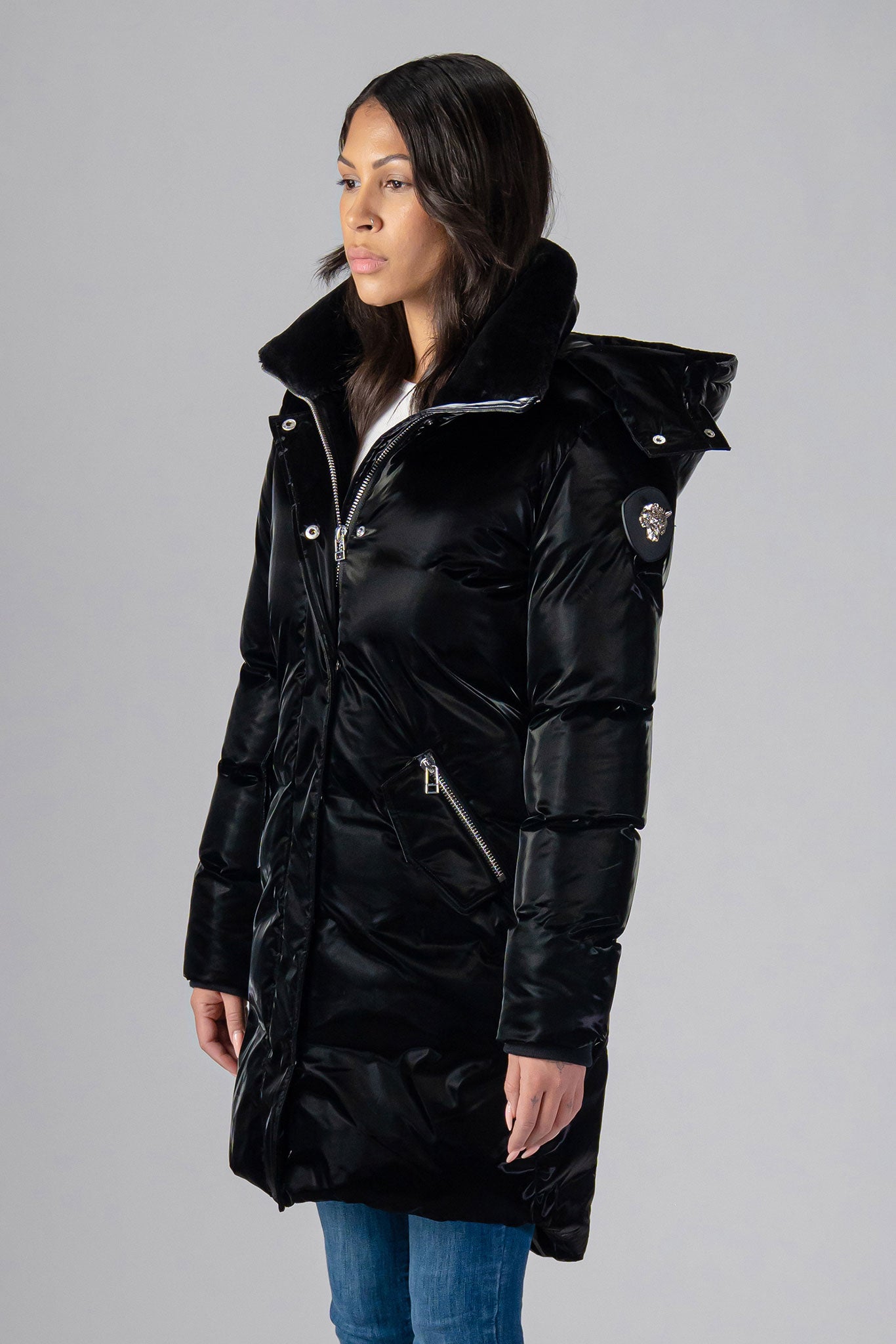 Woodpecker Women's Unquilted Penguin Long Winter coat. High-end Canadian designer winter coat for women in "All Wet Black" colour. Woodpecker cruelty-free winter coat designed in Canada. Women's heavy weight long length premium designer jacket for winter. Superior quality warm winter coat for women. Moose Knuckles, Canada Goose, Mackage, Montcler, Will Poho, Willbird, Nic Bayley. Extra warm. Shiny parka. Stylish winter jacket. Designer winter coat.