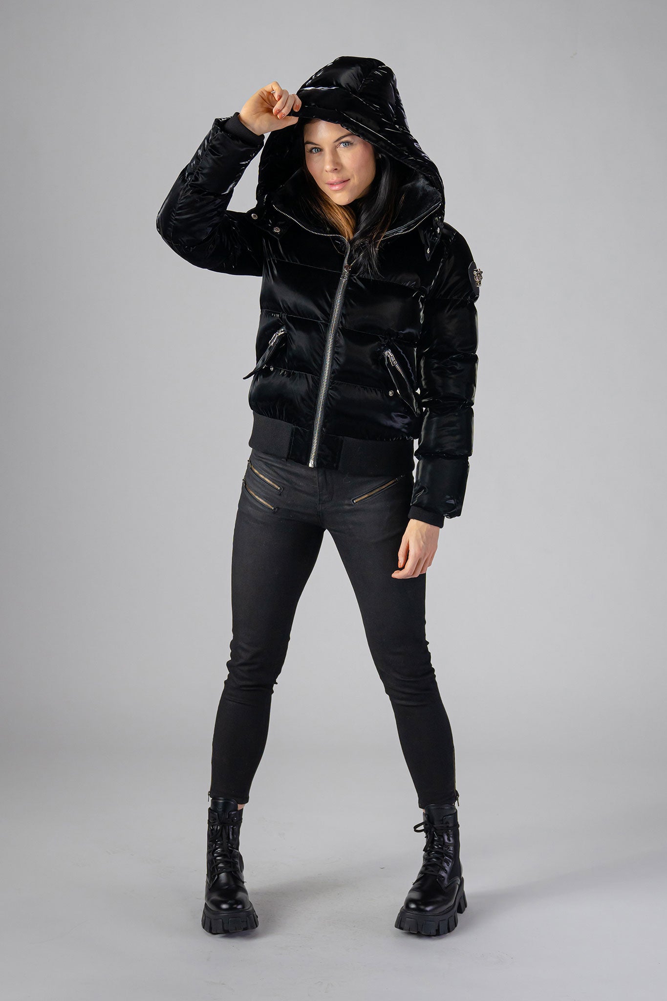 Woodpecker Women's Woody Bomber Winter coat. High-end Canadian designer winter coat for women in shiny “All Wet Black". Woodpecker cruelty-free winter coat designed in Canada. Women's heavy weight short length premium designer jacket for winter. Superior quality warm winter coat for women. Moose Knuckles, Canada Goose, Mackage, Montcler, Will Poho, Willbird, Nic Bayley. Shiny parka. Stylish winter jacket. Designer winter coat.