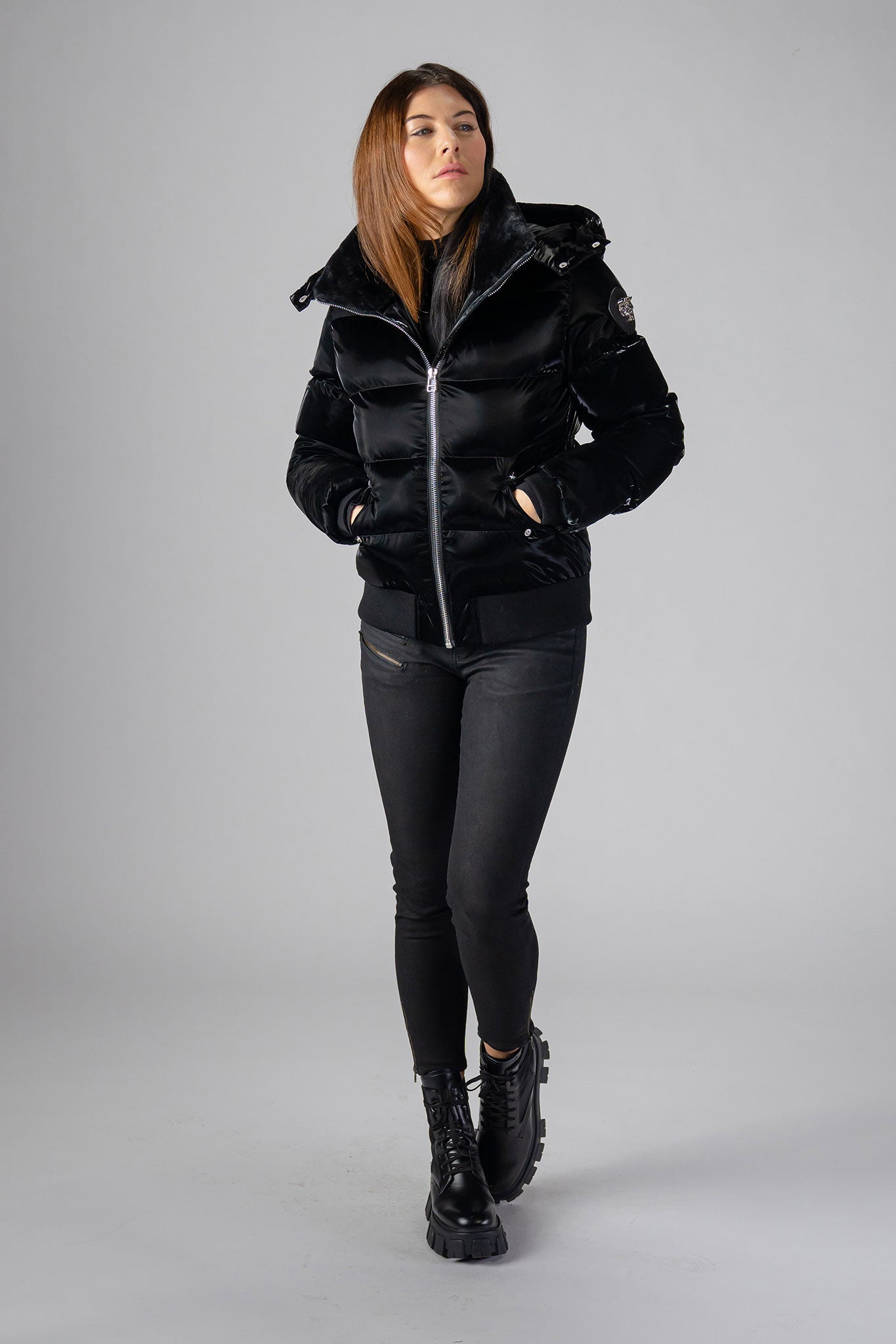Woodpecker Women's Woody Bomber Winter coat. High-end Canadian designer winter coat for women in shiny “All Wet Black". Woodpecker cruelty-free winter coat designed in Canada. Women's heavy weight short length premium designer jacket for winter. Superior quality warm winter coat for women. Moose Knuckles, Canada Goose, Mackage, Montcler, Will Poho, Willbird, Nic Bayley. Shiny parka. Stylish winter jacket. Designer winter coat.