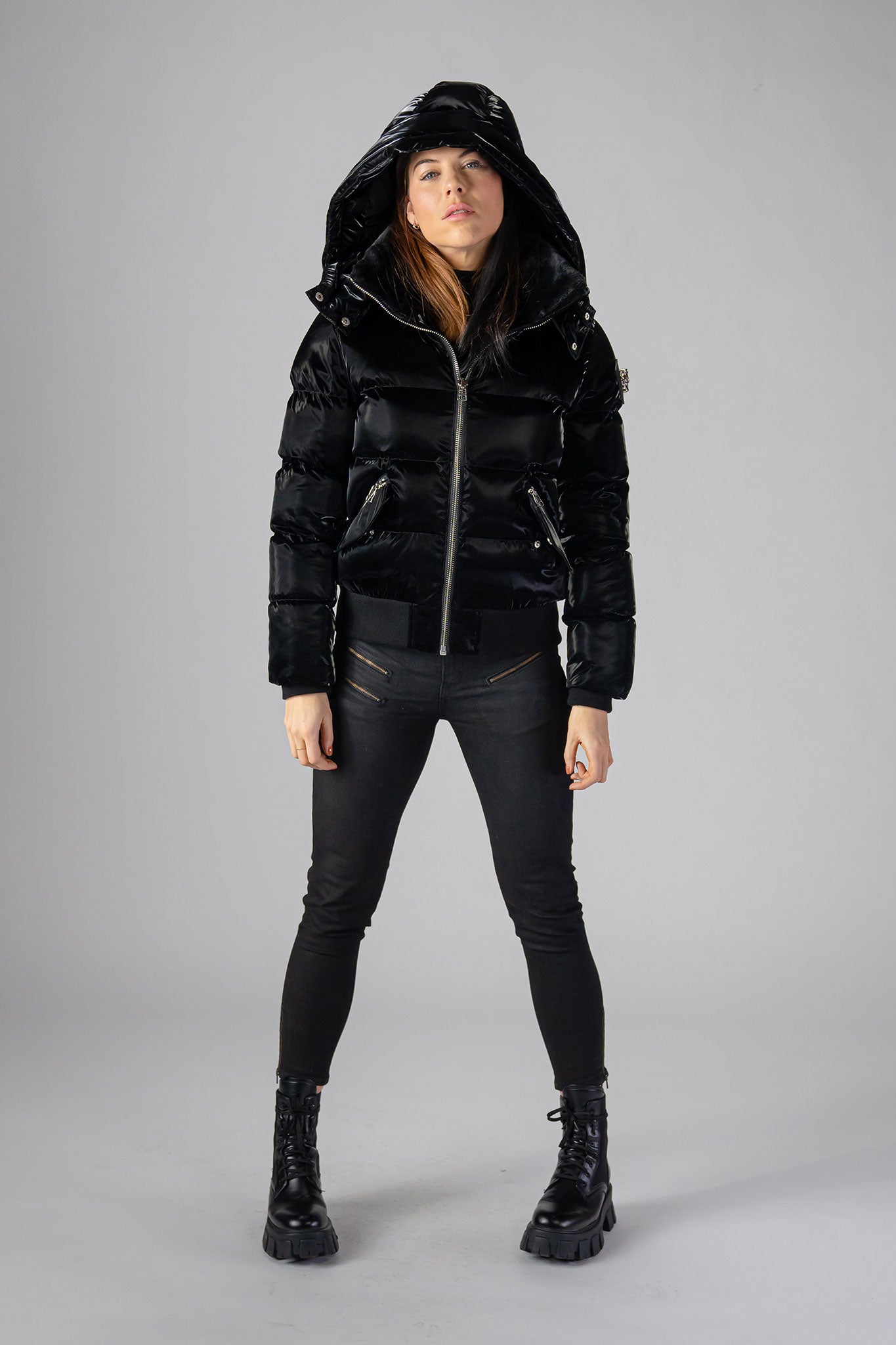 Woodpecker Women's Woody Bomber Winter coat. High-end Canadian designer winter coat for women in shiny “All Wet Black". Woodpecker cruelty-free winter coat designed in Canada. Women's heavy weight short length premium designer jacket for winter. Superior quality warm winter coat for women. Moose Knuckles, Canada Goose, Mackage, Montcler, Will Poho, Willbird, Nic Bayley. Shiny parka. Stylish winter jacket. Designer winter coat.