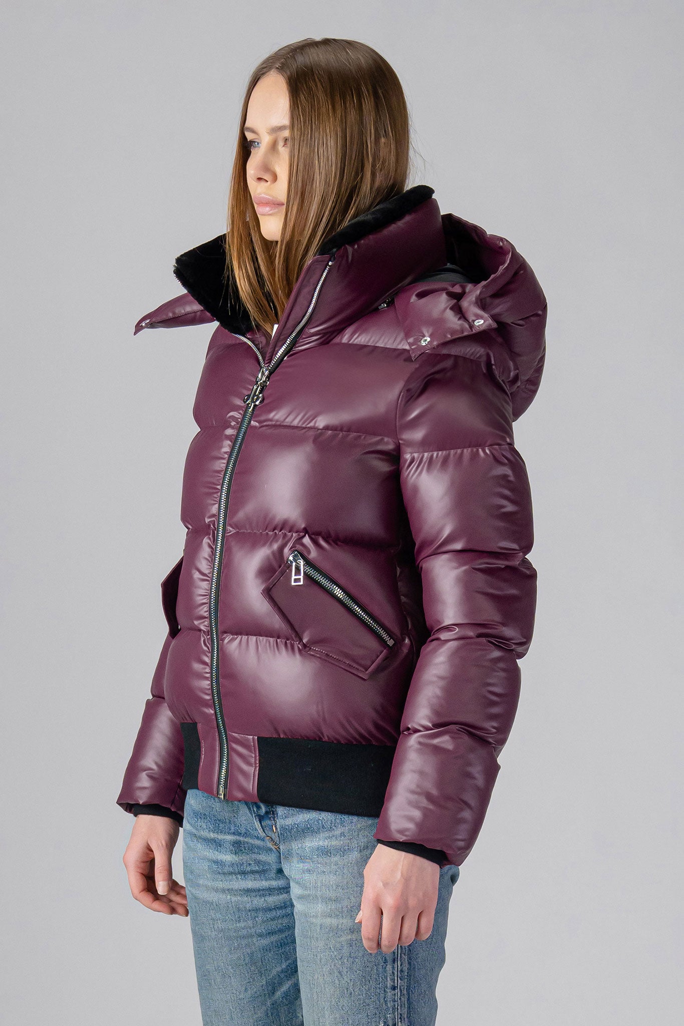 Woodpecker Women's Woody Bomber Winter coat. High-end Canadian designer winter coat for women in "Plum" colour. Woodpecker cruelty-free winter coat designed in Canada. Women's heavy weight short length premium designer jacket for winter. Superior quality warm winter coat for women. Moose Knuckles, Canada Goose, Mackage, Montcler, Will Poho, Willbird, Nic Bayley. Shiny parka. Stylish winter jacket. Designer winter coat.