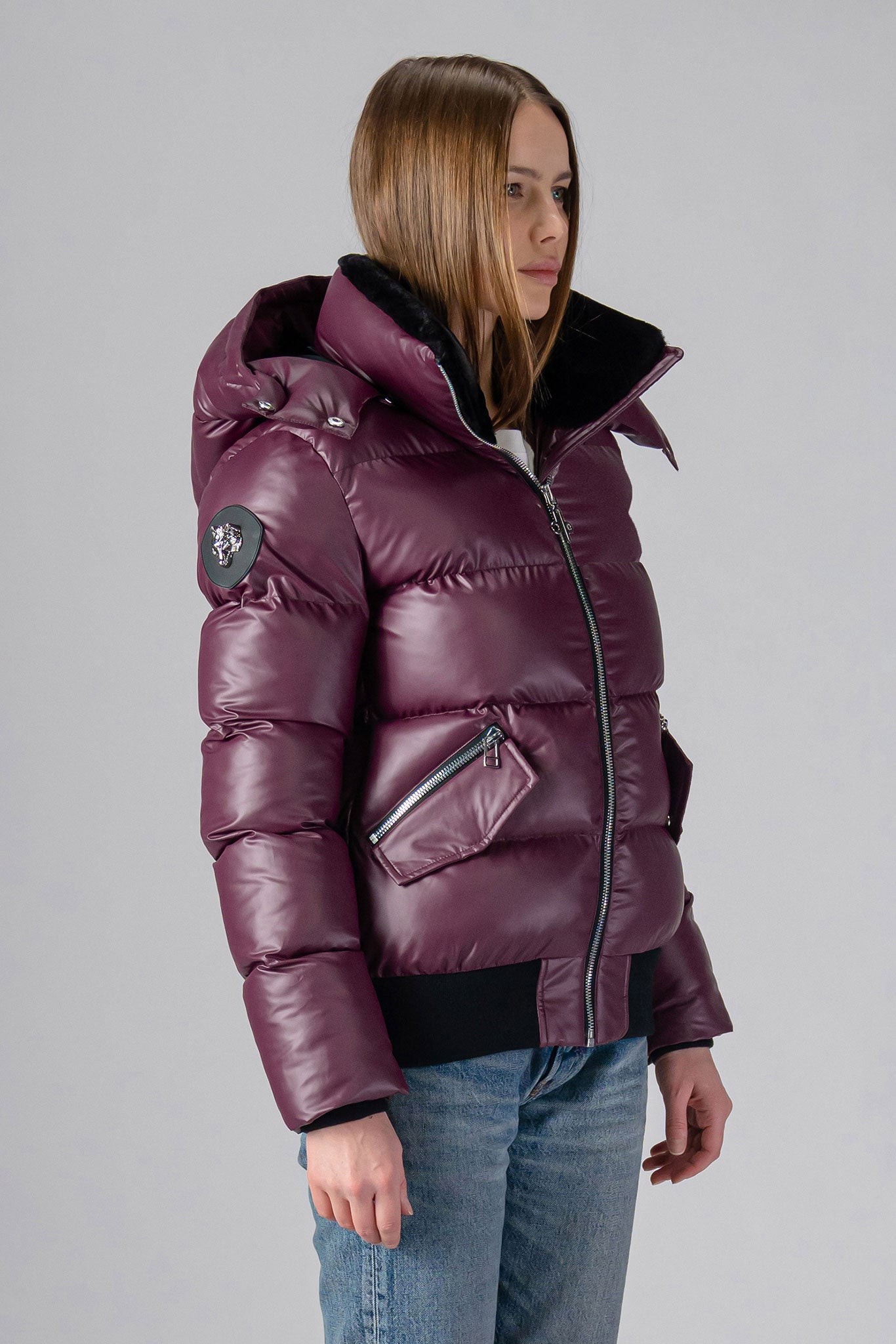 Woodpecker Women's Woody Bomber Winter coat. High-end Canadian designer winter coat for women in "Plum" colour. Woodpecker cruelty-free winter coat designed in Canada. Women's heavy weight short length premium designer jacket for winter. Superior quality warm winter coat for women. Moose Knuckles, Canada Goose, Mackage, Montcler, Will Poho, Willbird, Nic Bayley. Shiny parka. Stylish winter jacket. Designer winter coat.