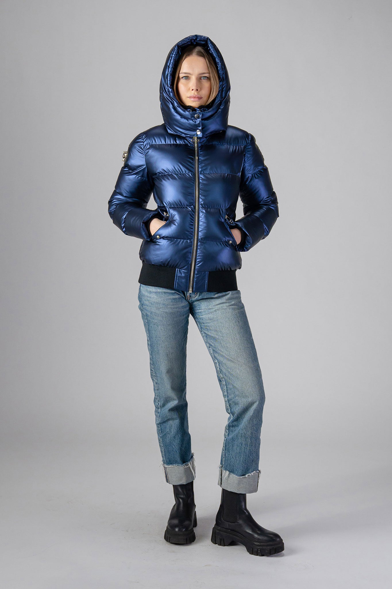 Woodpecker Women's Woody Bomber Winter coat. High-end Canadian designer winter coat for women in "Sapphire" colour. Woodpecker cruelty-free winter coat designed in Canada. Women's heavy weight short length premium designer jacket for winter. Superior quality warm winter coat for women. Moose Knuckles, Canada Goose, Mackage, Montcler, Will Poho, Willbird, Nic Bayley. Shiny parka. Stylish winter jacket. Designer winter coat.